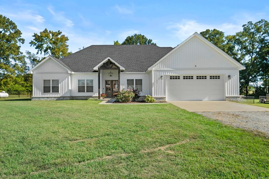 Welcome to this stunning, like-new home built in 2022 that offers the perfect blend of modern, comfort, and country charm. Featuring 4 spacious bedrooms and 2.5 bathrooms, this home provides plenty of room for family and guests. Enjoy open-concept living with stylish finishes throughout. The primary bedroom includes a walk-in closet, access to your back patio space, a double vanity in the master bathroom, with a walk-in shower and soaker tub. Step outside to your covered back patio complete with a cozy outdoor fireplace and 4.0+/- acres of flat, cleared land and a fenced in backyard area that is ready to go! Not to mention it comes with a safe room/storm shelter that is HEATED & COOLED in the garage! Move in ready and meticulously maintained, this home truly has it all! Schedule your showing now, before it's gone.