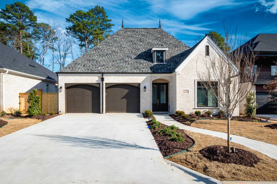 Discover timeless elegance w/ this newly constructed home in the picturesque, gated community of Mereville Pl in Chenal Valley. This luxurious residence exudes high-end craftsmanship & sophisticated design. Enter through a grand foyer w/ soaring 14' ceilings & exquisite golden oak wood floors inlaid w/ tile. The inviting entryway leads to a beautifully appointed dining rm featuring a wet bar, bar fridge, & wine cellar. The spacious family rm, adorned w/ ceiling beams & a fireplace, seamlessly connects to the chef's kitchen. This culinary haven boasts a stunning Quartz breakfast bar, GE stainless steel appliances, & 6-burner gas stove complete w/ pot filler. The primary suite offers a serene retreat w/ a private seating area & a spa-like bathroom. Enjoy the luxury of a dbl vanity, soaking tub, custom-tiled walk-in shower, & designer walk-in closet. The home's living & kitchen areas open to a backyard oasis. The covered patio creates the perfect setting for entertaining family & friends. Addl features include Pella windows, energy-efficient green technology, ceiling speakers & professional landscaping. Situated in a gated community, home offers an added layer of privacy & security.