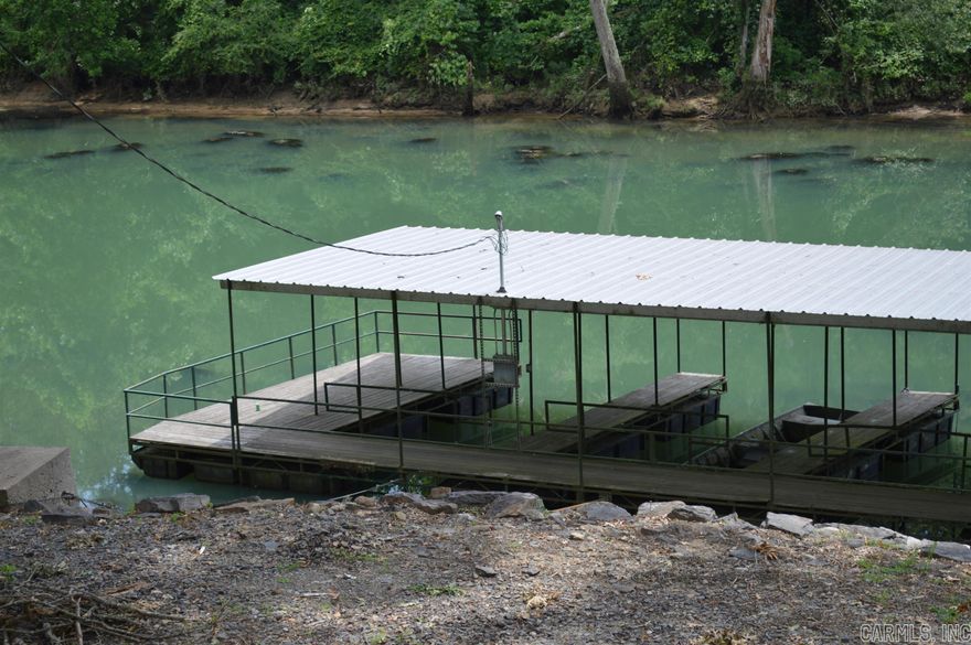 Little Red River, boat dock, & fishing are all available when you purchase this lot.  Fees cover garbage, laundry building w/free use of washers and dryers, pavilion for gatherings, common grounds, liability insurance. WHAT A DEAL!!!  Walk across the street to the river, to your boat dock and start fishing.  Boat slip is 3 slip from the left end of dock.  It is 1/2 of that slip.  See agent remarks for code to dock and laundry room.