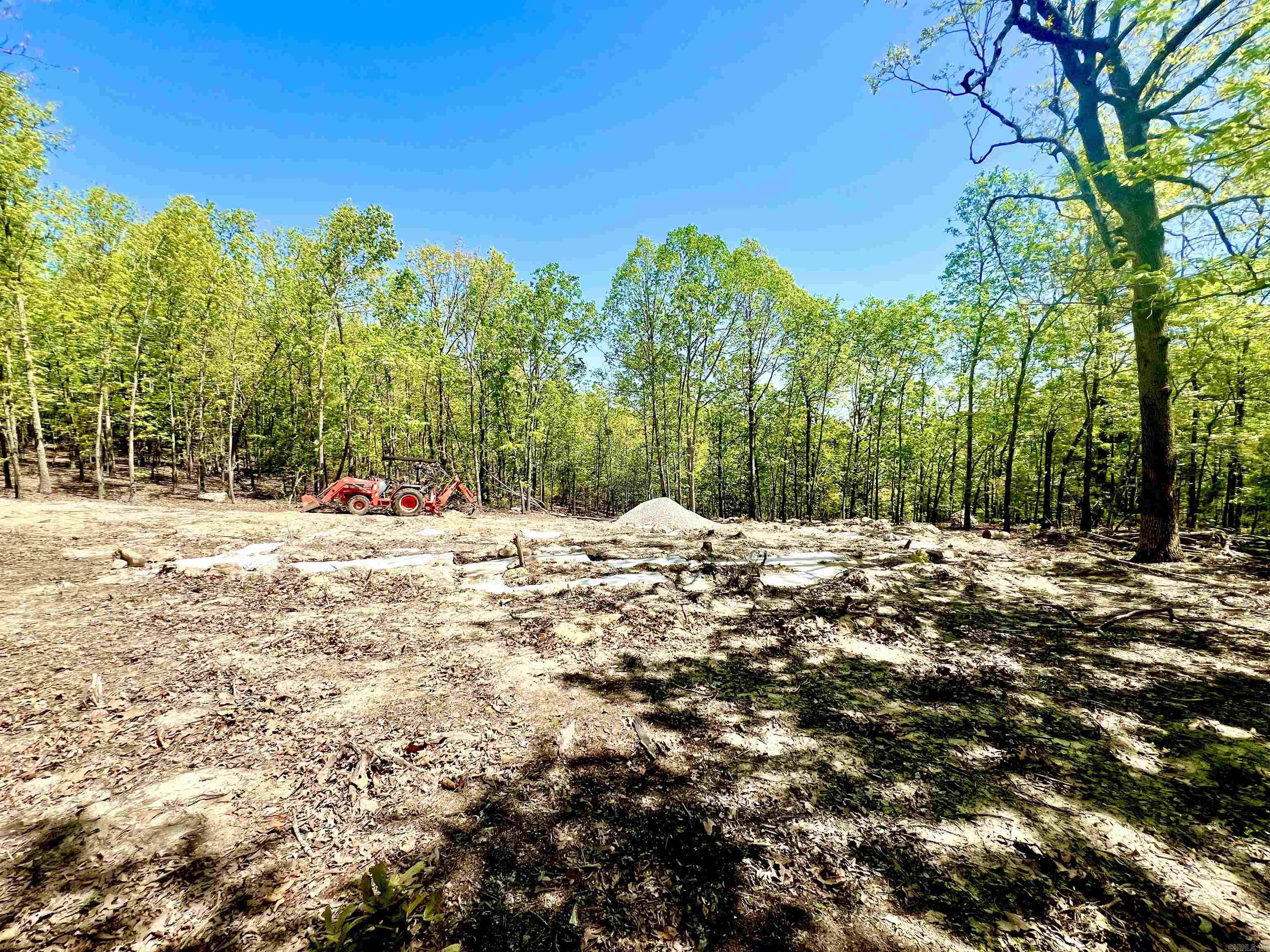 Five lots have been combined to create a little slice of heaven on 1.2 acres m/l, located 10 minutes from Mountain Home in the fabulous community of Briarcliff. This parcel is dream-home ready, with approval from the arch. review board. Foundation footings installed for a 1600 sq ft, 3 bed, 2 bath house with 2-car carport. Electrical service is active at the pole, septic is in the process of being installed. Septic permit completed. Water is ready to be hooked up at the road. Clearing and driveway are completed. Surrounded by the road on three sides, the foundation footings are located in the center of the 5 lots allowing for complete privacy and seclusion! More trees could be cleared to create a fantastic country view. Briarcliff is known for its amenities including lakes and trails, clubhouse, pool, playground, fitness center, etc. Only a short drive to Norfork Lake known for its bass, crappie and walleye fishing. Designated house plans available on American Made House Kits website.