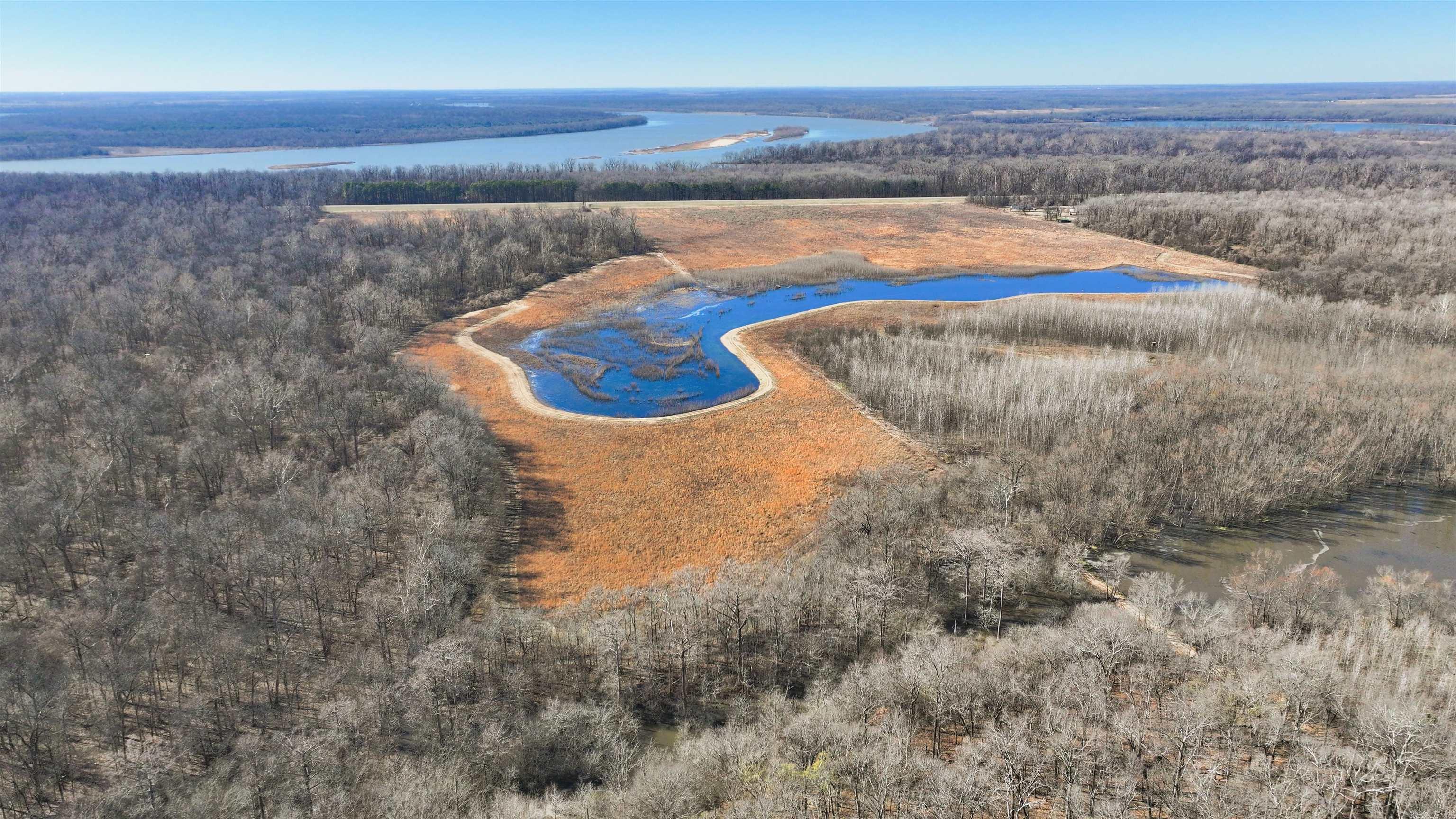 Nestled near the confluence of the Mississippi, Arkansas, and White Rivers, The Confluence 239 is a rare opportunity for outdoor enthusiasts and hunters. Spanning approximately 239 +/- acres, this property is a true wildlife haven, offering exceptional hunting for ducks, deer, turkey, hogs, and even alligators. The wetland impoundment created by the sellers provides vital habitat for wintering waterfowl, while the thriving population of whitetail deer and flourishing turkey population make this a hunter’s dream. 145 +/- acres enrolled in the Wetland Reserve Easement. This includes 0.75 miles of levee, a custom riser gate to manage water levels, and an electric well for flooding. The land also features 60 +/- acres of mature hardwoods and 85 +/- acres of hardwoods planted six years ago, offering prime wildlife habitat. A strategically placed 20-foot cypress blind and a 3-acre green timber hole, created by a picturesque slough running through the property, provide excellent opportunities for waterfowl hunting. Additionally, 38 +/- acres of open fields not enrolled in WRE offers versatility for planting or other uses.