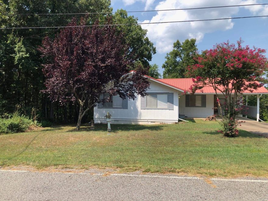 Updated Lake home with deck, large backyard and beautiful mountain view to enjoy. All Furnitures to convey at No Value. Home was repainted inside & out. Metal roof was replaced, tankless water heater, HVAC, flooring throughout the house, dishwasher, range, venthood microwave, light fixtures, doors, window blinds & light fixtures. Brand new sewer was installed 5/2025. Heating is electric but can be converted into gas. Seller use gas only for fireplace and standing heater located at the corner of the living room. This home is move-in ready & also perfect for Lake get away. Marina is less than a mile. Fairfield Bay offers 2 golf courses, 3 swimming pools, mini golf, bowling, and lots of hiking trails. Please don't forget to read Agent Remarks