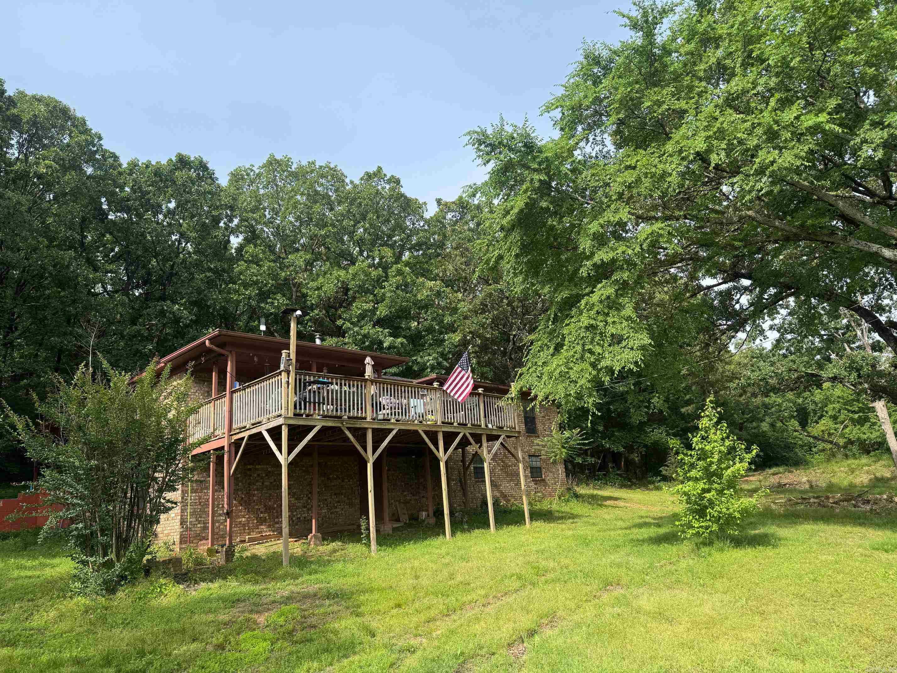 Discover country living with this 3-bedroom, 2-bath home on 11 acres just outside city limits. The home offers a large kitchen, a primary bedroom with private bath, and two additional bedrooms. A covered porch to overlook the peaceful property, which includes an outbuilding with electric and space for gardens, animals, or hobbies. This property needs some TLC but offers endless potential to create your dream retreat.