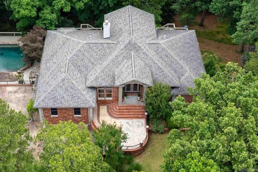 Perched atop a scenic mountainside, this stunning home offers breathtaking views in a private, gated neighborhood. A soaring vaulted ceiling and a wall of windows in the great room frame the gorgeous landscape, while doors along the back open to multi-level decks perfect for entertaining. The spacious layout includes both formal and informal dining areas, a large office/study with built-ins, and a double-sided fireplace connecting the great room and family room. The gorgeous kitchen features abundant custom cabinetry, counter space, SS appliances and a walk in pantry. The main level primary suite is a retreat with a private deck, luxurious spa bath, and huge closet. The lower level features a media/bonus/rec room with wet bar and kitchenette, two guest bedrooms with built ins sharing a large bath, a guest en-suite, and laundry room. An 800 SF basement includes a storm shelter for added security. Outside, enjoy a private oasis with a stunning gunite pool accented by natural stone, a patio with a gazebo, wet bar, and a beverage fridge. Recent updates include new interior/exterior paint and carpet while beautiful hardwood floors grace the main level. Ample storage thru-out. Come see!