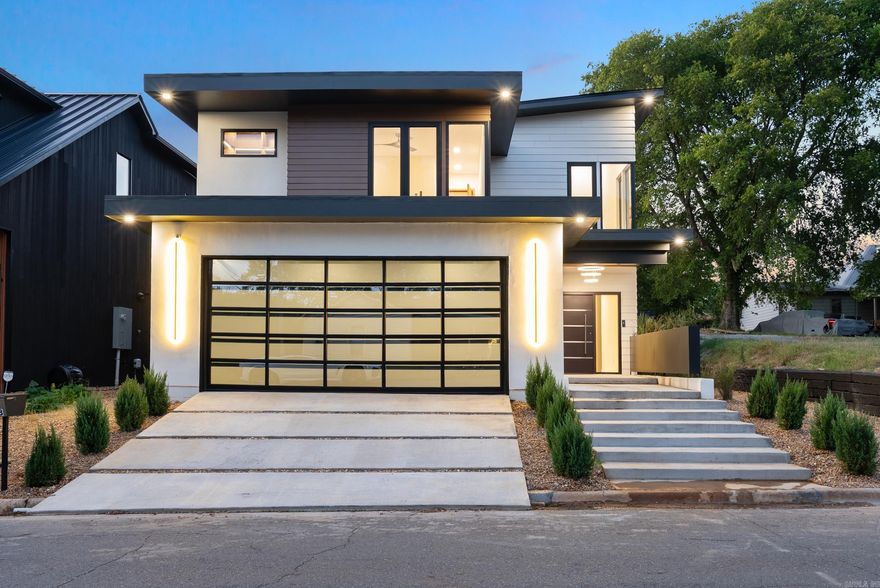 Welcome to your very own modern jewel box in the heart of downtown, a true architectural masterpiece where sleek design meets cutting-edge technology and ultimate comfort. This ultra-modern home showcases clean lines, premium materials, and an abundance of natural light from floor-to-ceiling windows, all anchored by a striking floating staircase. The home features a year-round heated and cooled gunite swimming pool and a gourmet outdoor kitchen perfect for entertaining. The spacious garage isn’t just for parking; it offers over 500 square feet of heated and cooled space, a mini-split system, and also features EV charging right on site. Throughout the home, you’ll find custom built-ins, LED-lit closets, and beautiful hardwood floors adding warmth and elegance. All appliances convey with the property, and the primary suite even includes its own private balcony. Every detail has been designed for stylish, effortless living—just steps from the best dining, shopping, and entertainment downtown has to offer.  Agents see remarks