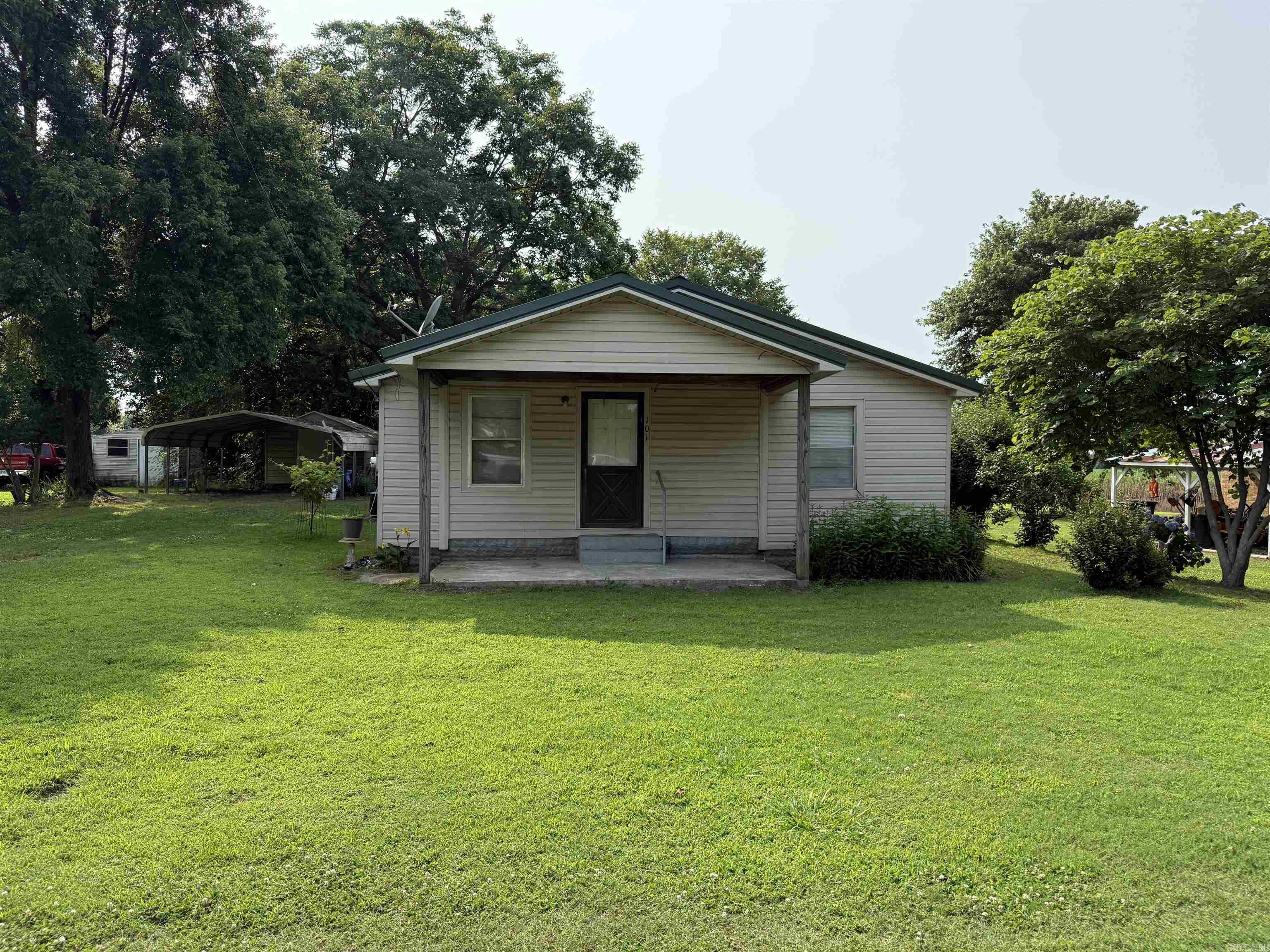 Peaceful Living in the Heart of Portia If you're looking for a cozy place to call home in a quiet, friendly community — this is it! This adorable home sits on a spacious yard in the charming town of Portia, tucked away on a peaceful street with beautiful shade trees and plenty of green space to enjoy. Just a short drive from the river, it's the perfect spot for those who love fishing, boating, or simply soaking in nature. The covered front porch offers a lovely place to relax and enjoy the breeze after a long day. Whether you're sipping your morning coffee or watching the sunset, you'll love the calm and comfort this home provides. Don't miss this affordable little gem with small-town charm and room to make it your own!