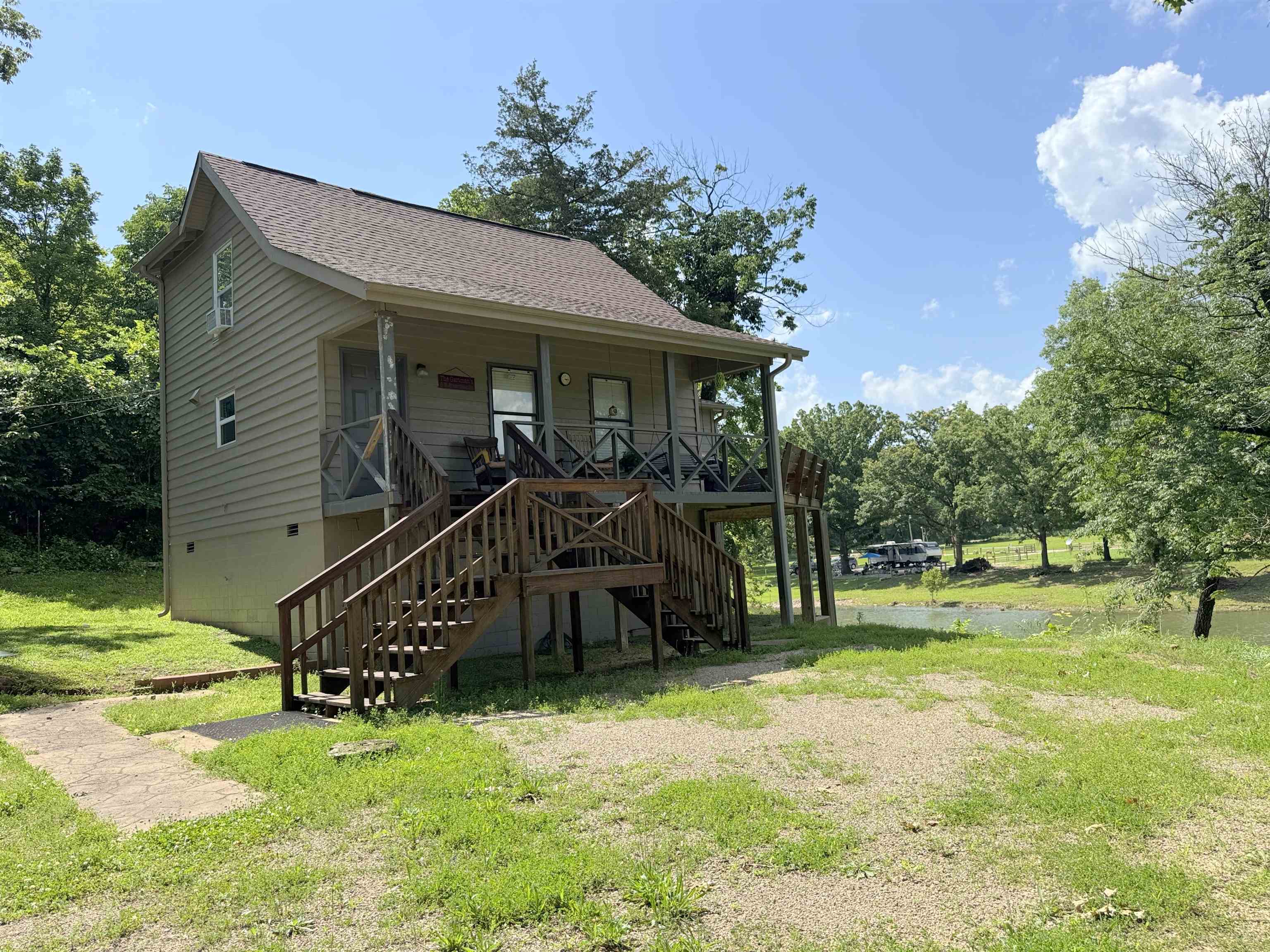 If you are looking for South Fork River frontage--with easy access to the river, this 3 bedroom 2 bath home should be on your short list. This is an opportunity to acquire a fully furnished home with central HVAC, kitchen appliances, washer and dryer included. The living quarters are above past flood levels, per the owner.The tall crawl space has ample room for storing yard tools and water toys. There is enough headroom for this "crawl space" to become a finished basement, with an outside access only. A deck wraps two sides of the house with plenty of room for enjoying the out of doors and some really great views of the river.