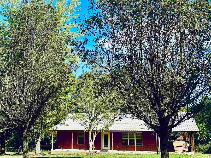Great price! Move-in ready! This beautiful 2-bedroom, 1 bath, cabin sits on approximately 4 acres with a large detached garage/shop, 16X32 barn with concrete floor and lean-to, and a nice established garden area.  The well-designed cabin has an inviting open concept living/kitchen combo with wood ceilings, stainless appliances, wood burning stove, propane wall heater backup heat source, and a large bath/laundry room, Located in the Ozarks just off of paved Trout Farm Road in Searcy County and minutes from world renown Buffalo National River and AR Game and Fish's Howard Hensley Wildlife Management area, this is an ideal location for enjoying the beauty of nature and the outdoors; fishing, hunting, hiking, and horseback/ATV riding to name a few. The spacious covered wrap around porch is one of the cabin's best features with ample space for a private back porch outdoor living area, savoring morning coffee in the porch swing, grilling, or simply quietly watching the sunset or the abundance of white-tail deer and small game. Priced right to sell! Call today for more information or to set up an appointment to view.