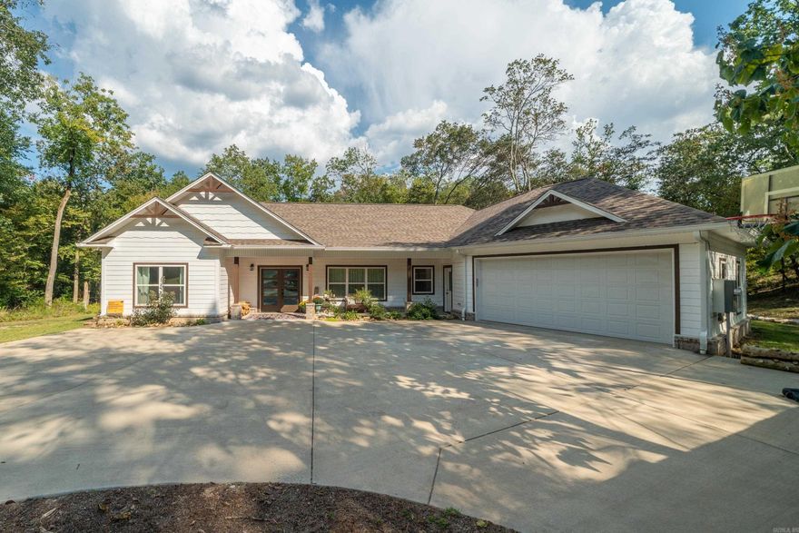 Discover your perfect retreat in this charming 3-BR., 2-BA. home nestled in a private setting that feels like your own personal sanctuary. With 2,398 sq. ft. of thoughtfully designed living space, this property offers the ideal blend of comfort and tranquility. The real showstopper? A beautiful creek that flows gracefully into Lake Catherine, creating a picturesque backdrop that changes with the seasons. Imagine sipping your morning coffee while listening to the gentle sounds of flowing water – it's like having nature's own soundtrack right in your backyard. The spacious primary bedroom provides a peaceful escape, while two additional bedrooms offer flexibility for family, guests, or that home office you've been dreaming about. The large sunporch is perfect for lazy Sunday afternoons, whether you're diving into a good book or entertaining friends. This isn't just a house; it's your gateway to lakeside living where every day feels like a vacation. Ready to make some waves in your new home?