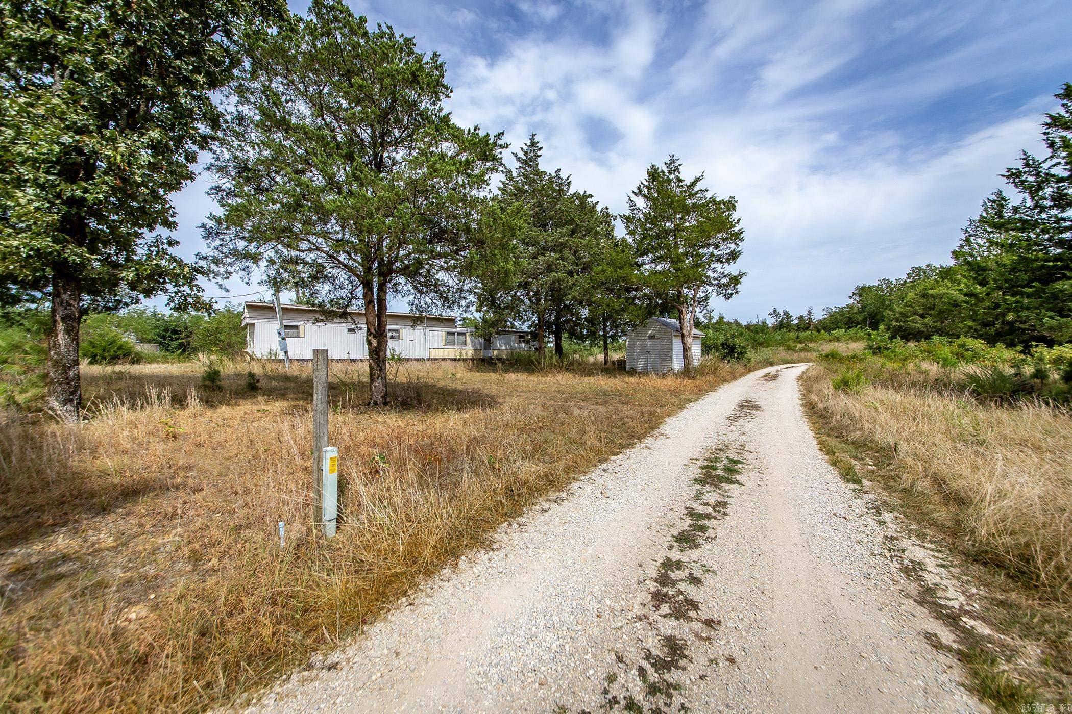 Gorgeous vista mountain views atop this beautiful 16.3 acre mountain retreat. Complete with city water, septic, power, and a tornado shelter. Old mobile has no value. Fiber to be installed at the end of the year. There are no restrictions. 25 minutes to Mountain View. Call today to schedule an appointment.