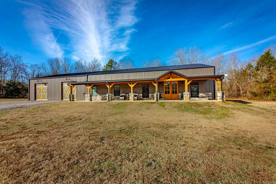 Tucked away on 25 private acres, this one-of-a-kind property blends rustic elegance with modern comfort. The approx. 4,000 sq ft home includes 2,400 sq ft of living space plus an impressive 1,600 sq ft attached, insulated garage/shop. The home offers 4 beds, 2.5 baths, an open-concept layout, durable stained concrete floors, high ceilings, & beautiful, exposed beams. The kitchen is a true centerpiece featuring a custom epoxy island, double ovens & an oversized walk-in pantry perfect for entertaining and everyday living. The garage/shop includes 3 doors (one John Deere entrance, bring all your toys!), storm shelter beneath the slab, zoned HVAC for your comfort and convenience, spray foam insulation, abundant storage & a separate metal carport w/ lean-to. A detached tiny house offers flexible space for an office, guest quarters, multigenerational living or potential rental income. Enjoy peaceful country living where from your expansive front porch you can view your private pond w/deer stand & abundant wildlife, while remaining close to town amenities. High-speed fiber internet available. No HOA. Sellers love their home but are relocating due to an unexpected job transfer.