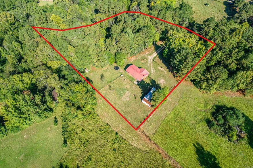 Brick country home on over 2 acres with pond and creek.  2 bedroom 1 bath with plenty of room to roam. Home has city water with septic. Duct work has been redone. It has metal roof.  Storage/shop