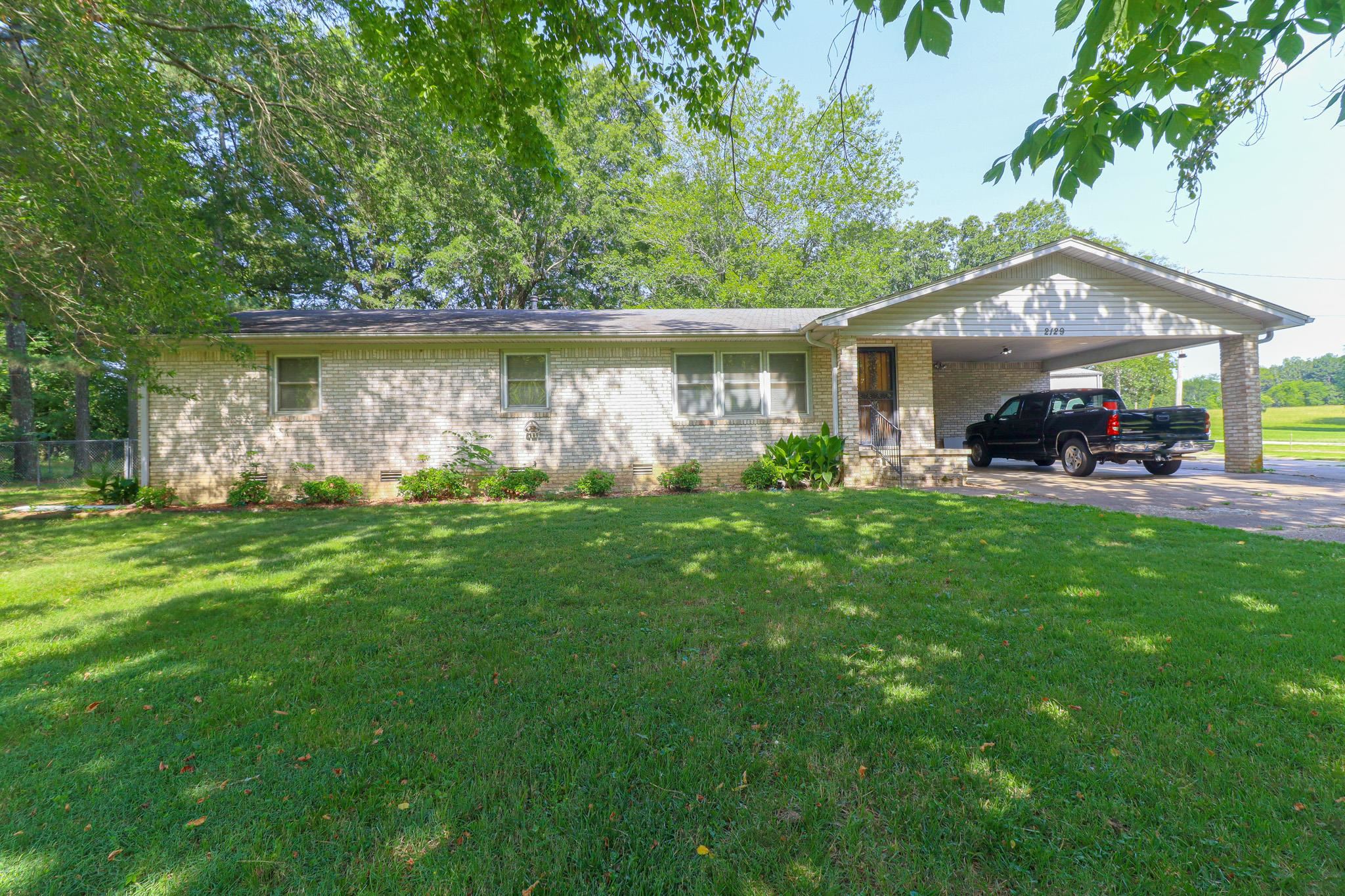 Welcome to country living within the city limits of Jonesboro! This charming all-brick home features 3 bedrooms and 2 bathrooms, including a spacious master suite with two large closets and a walk-in shower. You'll love the flexibility of the extra room perfect as a formal dining space or a cozy den complete with a fireplace. The kitchen is ideal for family meals, featuring Corian countertops, under-cabinet lighting, and a warm, inviting atmosphere. Sitting on a shady corner lot, the fenced backyard offers privacy and space plus a storm shelter for added peace of mind. And there's more! A workshop with two roll-up doors awaits, fully equipped with electricity, water, heating, and even an air compressor. The shop also includes a concrete drive and carport ideal for hobbyists, mechanics, or extra storage. This one won't last long on the market. Call or text for more information or to schedule your tour!