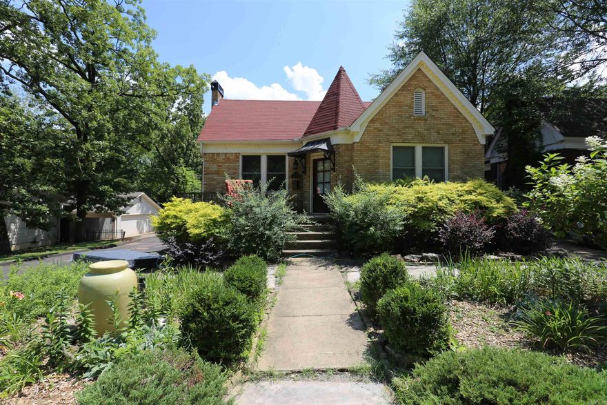 Absolutely Charming and Thoughtfully Updated! This light-filled home showcases stunning hardwood floors, a cozy fireplace, and elegant arched doorways. The beautifully renovated kitchen features soapstone countertops, custom cabinetry with soft-close drawers and pullouts—perfect for both everyday living and entertaining. Major upgrades include a new roof (2021), insulated windows (2019), tankless hot water heater, and updated electrical and plumbing systems for modern comfort and efficiency. Located directly across from Prospect Terrace Park, the exterior is just as inviting with a fully fenced backyard, mature landscaping, a stone patio, firepit area, and charming arbor—ideal for outdoor gatherings. Enjoy peace and privacy on a quiet street, plus the bonus of a wired backyard shop, great for a studio or workspace. Tons of natural light throughout make this home a true standout.