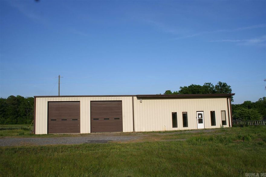 Large shop with living quarters and office (3200 sq ft total) on one acre.  1920 sq ft shop area with two RV bays and extra open area, gas heaters.  1280 sq ft heated and cooled apartment and office space.  Apartment features nice kitchen, living room, bedroom, full bath and walk-in closet, attic storage above.  Washer and Dryer hookups.  Office consists of two rooms and half bath.  Chain link fenced area.  Gravel drive/parking. Used as personal residence last 10 years, prior usage painting business.