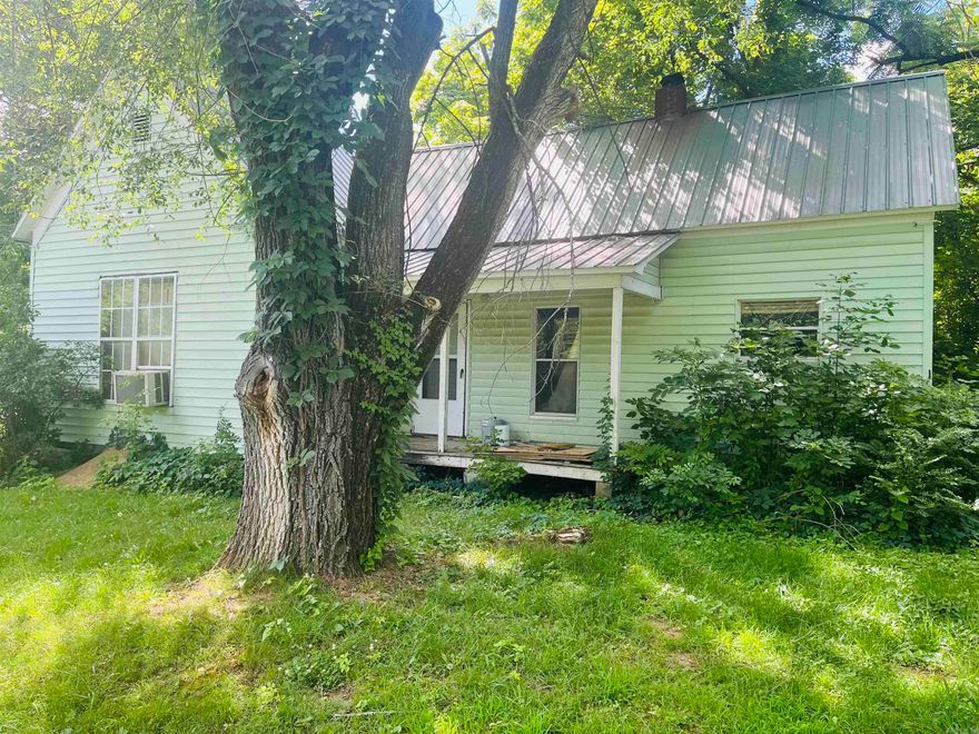 This quaint, cottage-style house is near a beautiful stretch of Cove Creek. Situated on a large and well-kept lot, this domicile has turnkey or renovation potential. Enjoy the shade of the ancient trees in a quiet and private section of this small town.
