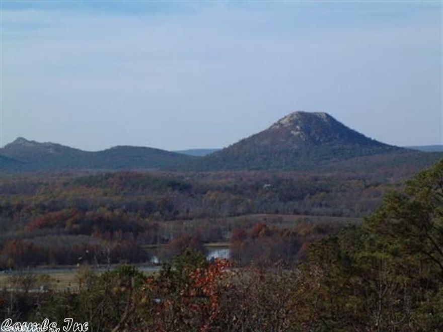 Sloping and wooded.  View of the AR River.  Gated area with high tech security system.  POA dues $70.00 per month, per lot.  One time fee of $1,000 per lot for future road repair.  5 acre tracts in the city with all utilities. Some have fabulous river views.  Some lots need pump for sewer.  See showing remarks.  Gated area.  Taxes to follow