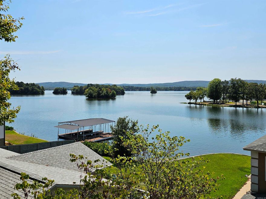 This third-floor condo offers stunning views of the main channel from both the master bedroom and living room. The open floor plan, complete with a fireplace, makes it a cozy year-round lakefront home, perfect for family living and entertaining, or could be a GREAT short term rental. Enjoy the excitement of race meets through fall on the lake. All of the furnishings, including the outdoor furniture on the spacious deck, are included, allowing you to take in the panoramic lake views right away. The condo comes with two covered parking spaces and a storage room. It's conveniently located near top restaurants and shopping, and it has it's own boat dock!