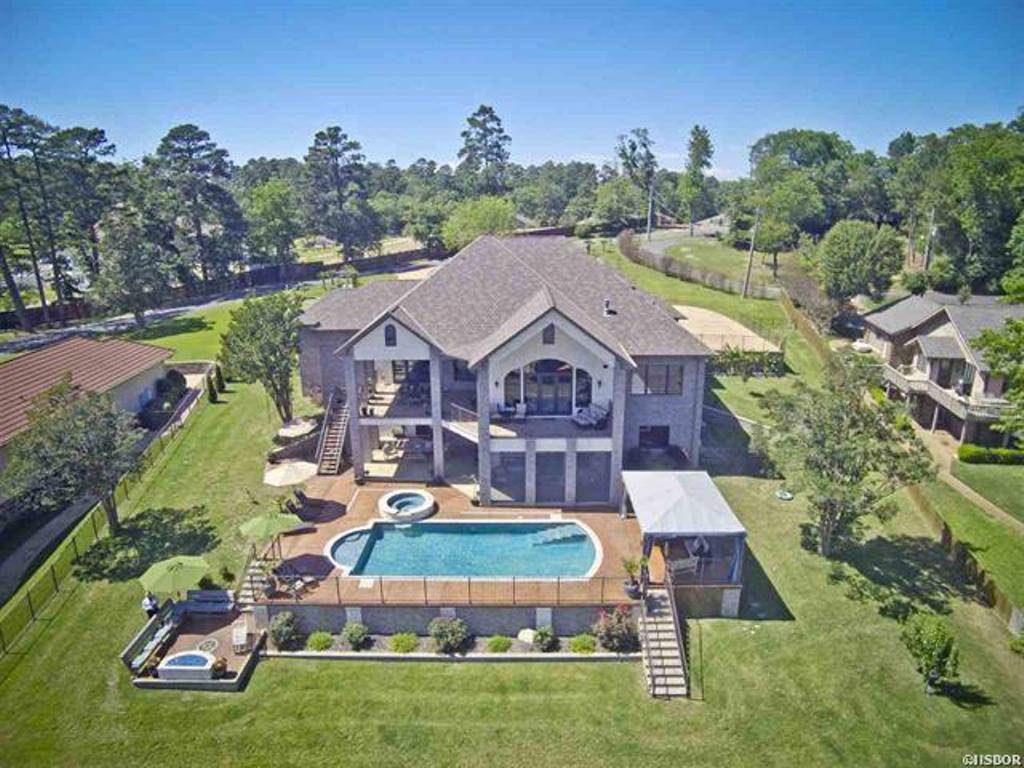 First time on the market for this Elegant Lake Home w/ stunning view! This home has it ALL! Porcelain Floors, Hardwood, Cortez Counters. Chef's Kitchen w/Food Steamer in Island. Surround sound in & outside, Workout room w/ Dry/Steam Sauna, Generator,3 zoned H & A ,Video alarm system, Storm room. Outdoor features: Heated/Show lights salt water Volley Ball pool over looking lake. Gas fire pit, Screened patio, Cabana & 3 car garage (One with H/A), Phantom Screens. 2 stall Boat Dock w/Lift, 2 Wave Runner docks
