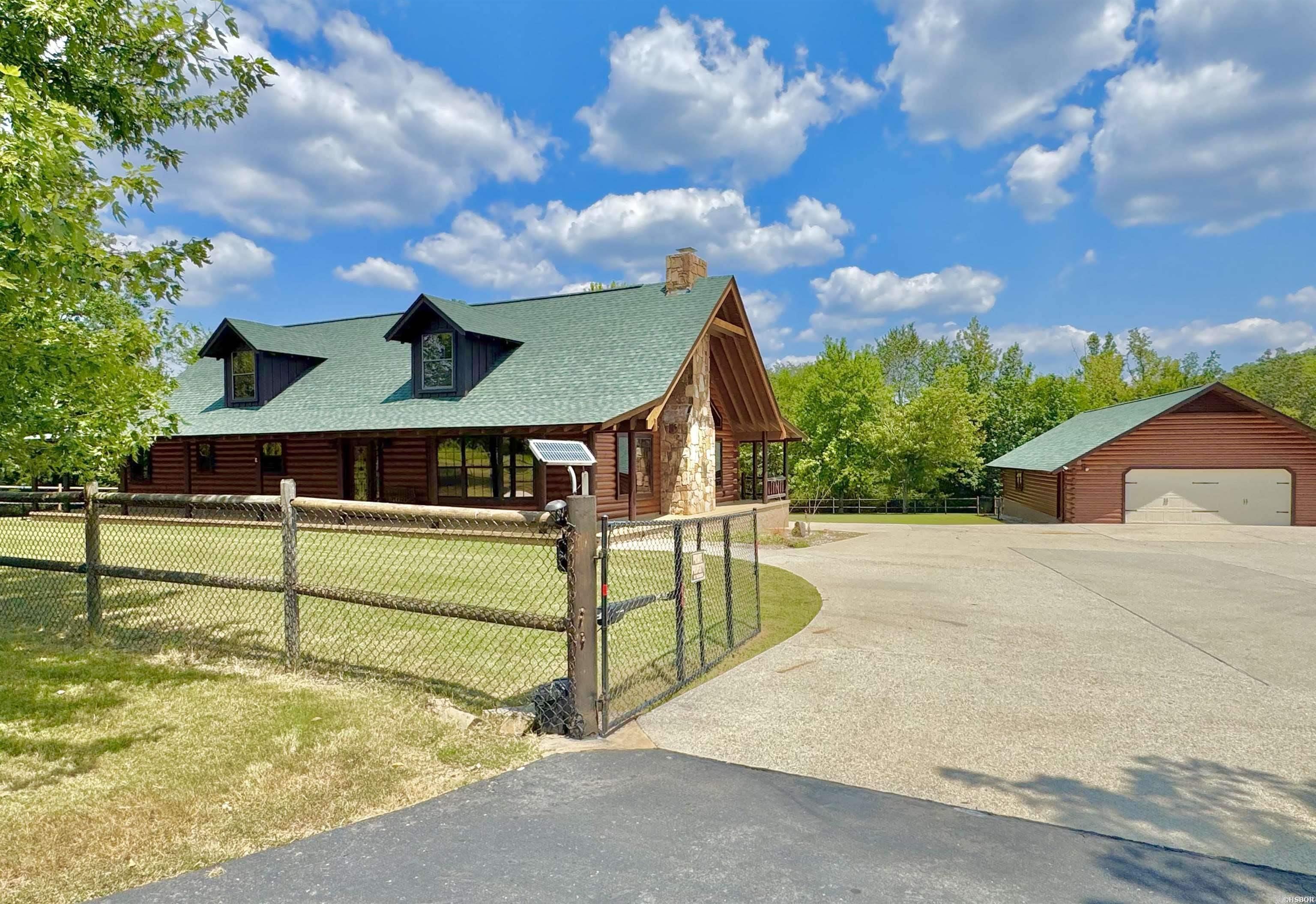 Situated 3 miles from Brady Mountain Resort on Lake Ouachita and only 15 minutes from Hot Springs, this custom built 2 bedroom, 2.5 bath home has over 3000 sq.ft. and offers the perfect blend of privacy, natural beauty and convenience. Nestled on 9 acres with a creek running through the property, it’s an ideal setting for outdoor enthusiasts, horse lovers or anyone seeking a peaceful retreat. Inside, the home features an open floor plan with soaring ceilings and a massive stone woodburning fireplace anchoring the living space. The spacious primary suite includes a large en suite bathroom, while the warm wood interior creates a cozy, welcoming atmosphere throughout. An impressive 1,800 sq. ft. garage space offers endless potential—store your lake toys, set up a workshop, or convert the space into a guest house. With plenty of room for horses or livestock, this property is as versatile as it is beautiful. And with its close proximity to Lake Ouachita, this property would flourish as a short-term rental. Adventure, relaxation, and income potential all in one!