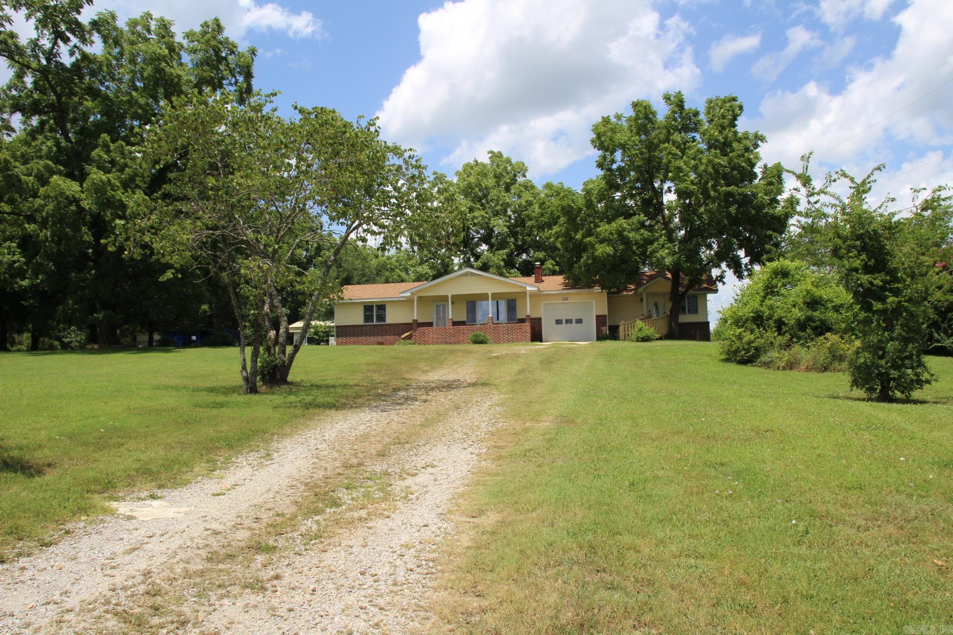 This charming home on the outskirts of town gives you the country feel but allows you to have the close convenience of schools, grocery stores and other needs you may have. This home sits on 1 acre with mature trees, city water and a beautiful yard. There are 3 bedrooms, 3 baths, spacious kitchen and lots of storage. You will also find an additional 765 sq ft building that can be used for hobbies, storage, work area, the possibilities are open.
