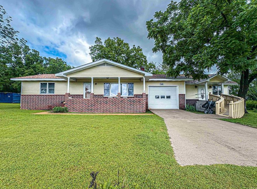 This charming home on the outskirts of town gives you the country feel but allows you to have the close convenience of schools, grocery stores and other needs you may have.  This home sits on 1 acre with mature trees, city water and a beautiful yard.  There are 3 bedrooms, 3 baths, spacious kitchen and lots of storage.  You will also find an additional 765 sq ft building that can be used for hobbies, storage, work area, the possibilities are open.