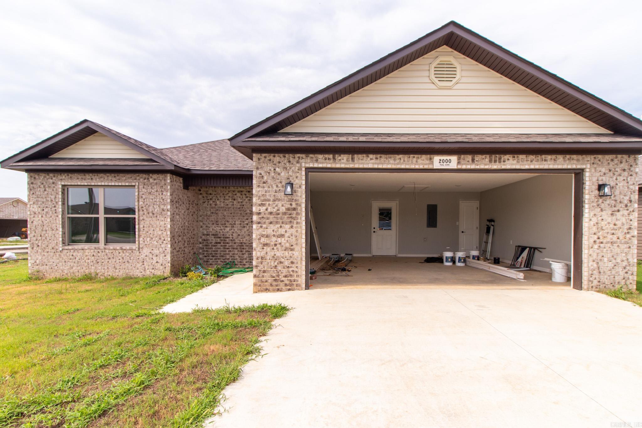 Introducing 2000 Teal Cove, an impressive new construction home situated in the picturesque community of Lake City, Arkansas. Boasting 1,337 square feet of modern elegance, this residence offers a harmonious blend of comfort, style, and exceptional craftsmanship. Upon entering, you'll be captivated by the sleek and contemporary design, accentuated by the polished concrete floors that flow throughout the entire living space. The kitchen is a culinary enthusiast's delight, featuring pristine white cabinets that seamlessly complement the overall aesthetic. Prepare gourmet meals with ease while enjoying the seamless flow of the open-concept layout. Crafted by the reputable Cooper and Son Construction, this home exemplifies superior construction and meticulous attention to detail. The bedrooms provide a serene retreat, with ample space for relaxation and rejuvenation. The bathrooms exude luxury with their modern fixtures and thoughtfully selected finishes, creating a spa-like ambiance.