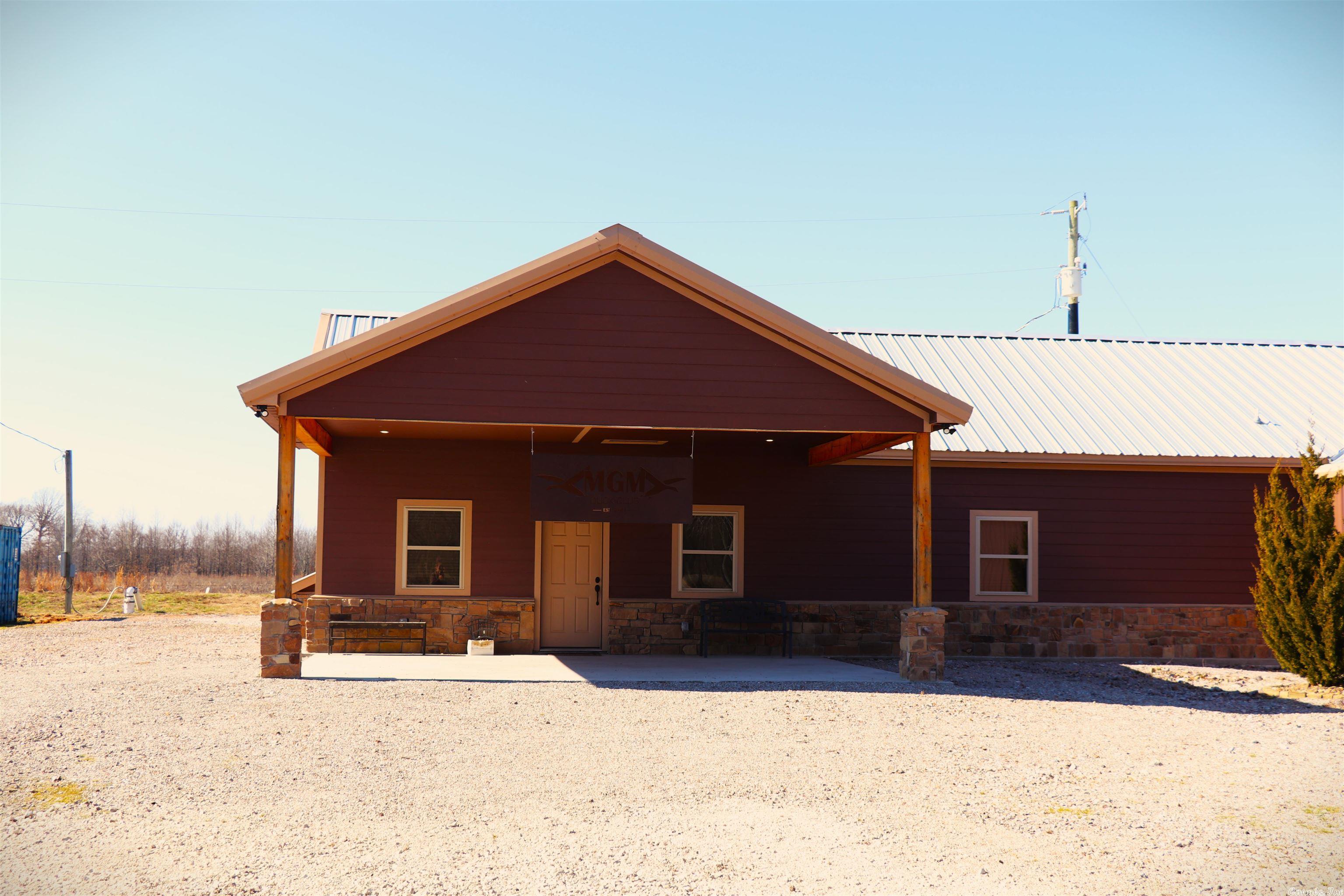 Lodge & 40 acres selling fully furnished (ranger & 1 striped bass mount) do not convey. Custom woodwork throughout with wood from Oaklawn Racing as well as 2 other equine centers. Some of the trim wood is from a few oak trees that were blown over onsite during a windstorm roughly 2 years ago. Hunting areas flooded by a submersible electric well that sits just behind the cabin. Timber is leveed. Grand Prairie water and new septic in 2021.