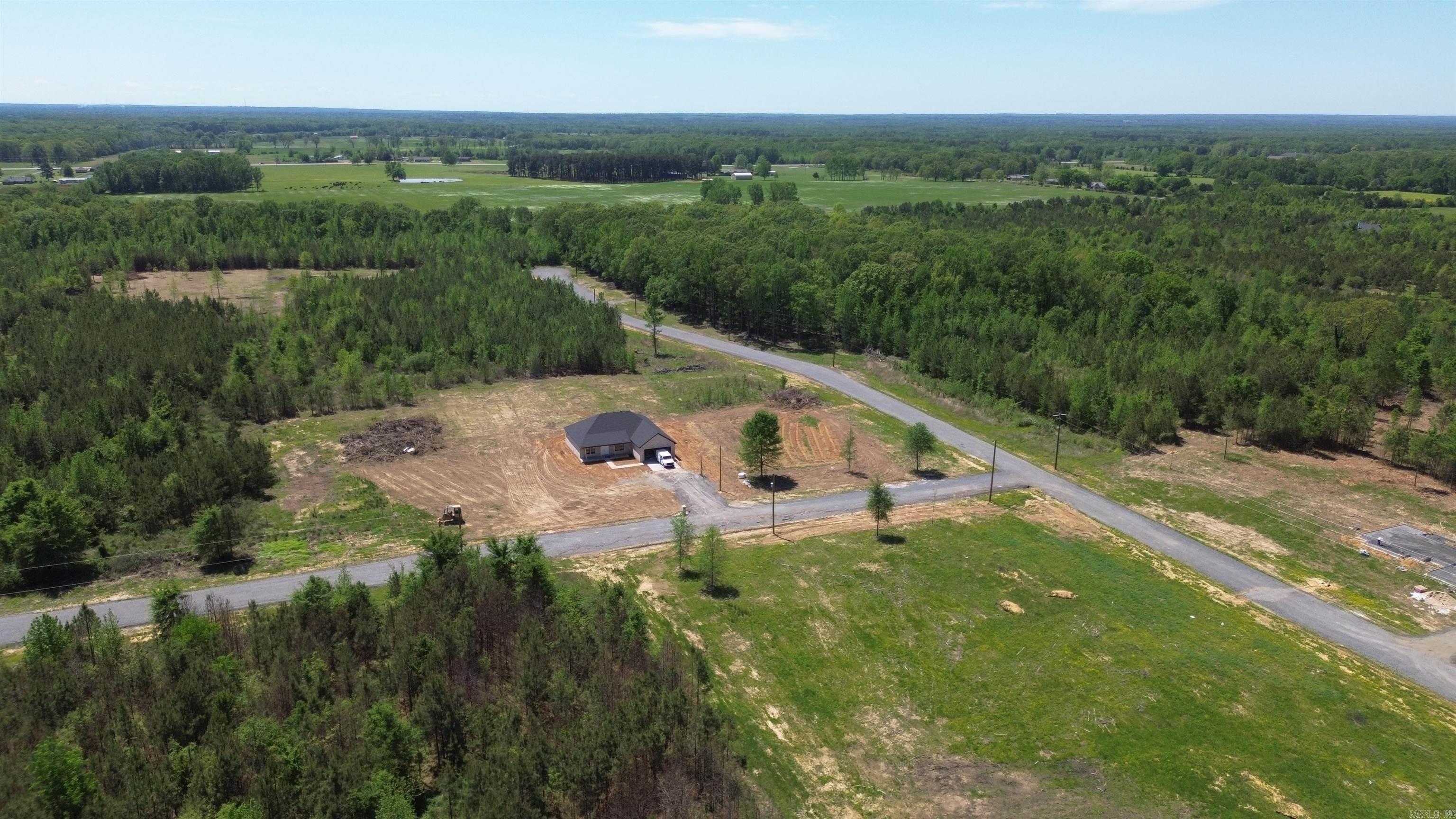 Beautiful flat 5.73+/- acre lot right outside of city limits, perfect spot if you are looking to build! Gorgeous new construction houses are going in all around. Enjoy great views of the countryside in a quiet area while only being a few minutes from the interstate. 20 mins to Vilonia, 20 mins to Searcy, & 20 mins to Cabot. Water and electric are available at the road. No mobile homes. Minimum square footage of 1700.