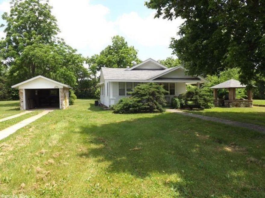 3.15 beautiful level acres of ground located just a stone's throw from Ash Flat's courthouse, bank, and shopping. Native stone home, garage, and gazebo were built in Ash Flat's early days, construction date unknown.  The home has 2 bedrooms, 1 bath, living room, kitchen, dining room, and a 16x24 bonus room built on the back, propane wall heat and 2005 central air. This would be a fantastic location for anyone working in the area who has a taste for history and a small acreage of land inside the city limits.