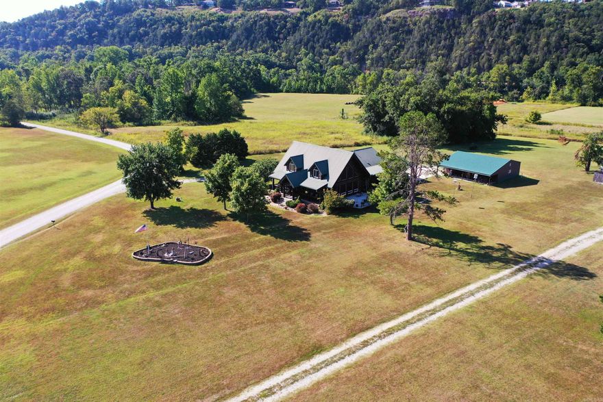 Discover your perfect White River Valley Sanctuary with this stunning 3 bedroom/3 bath log-style custom home sitting on a manicured, 2.36-ac/ml level lot in the majestic White River Valley. Just a stone's throw from the public boat launch, this property offers a seamless blend of rustic charm and modern luxury. Inside, be captivated by the open floor plan,well designed & maintained Kitchen,warm hardwood flooring,and vaulted ceilings that amplify the natural light and breathtaking views.Comfort is guaranteed year-round with a highly efficient,three-zone geothermal heating and cooling system,which also promises significant energy savings. Outdoor living is a dream with a large covered porch and an open deck, perfect for entertaining or relaxing while soaking up the views of the serene White River Valley. For the hobbyist, entrepreneur, or adventurer, the property includes a fantastic 30x40 metal shop building complete with RV electrical and water hookups, providing endless possibilities.