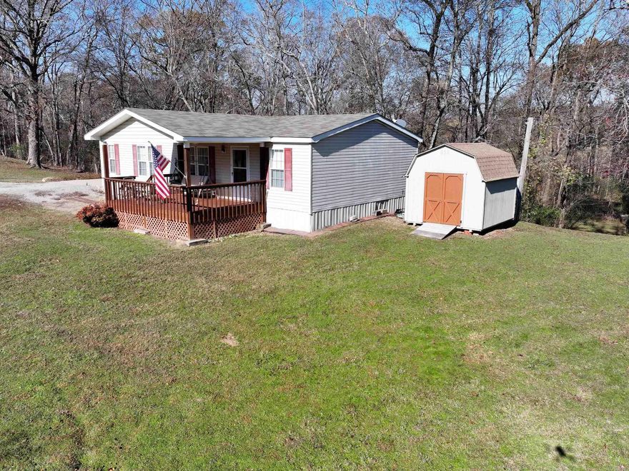 Very well maintained 3 bedroom/2 bath mobile home on 3 +/- acres. This home has a brand new (2024) central cooling system, new roof in 2018, a storage building with a new roof and doors installed in 2023, a 2-car carport, concrete pad, porch and more! Featuring a small creek that runs through the property, on serene setting in Fountain Lake School District.