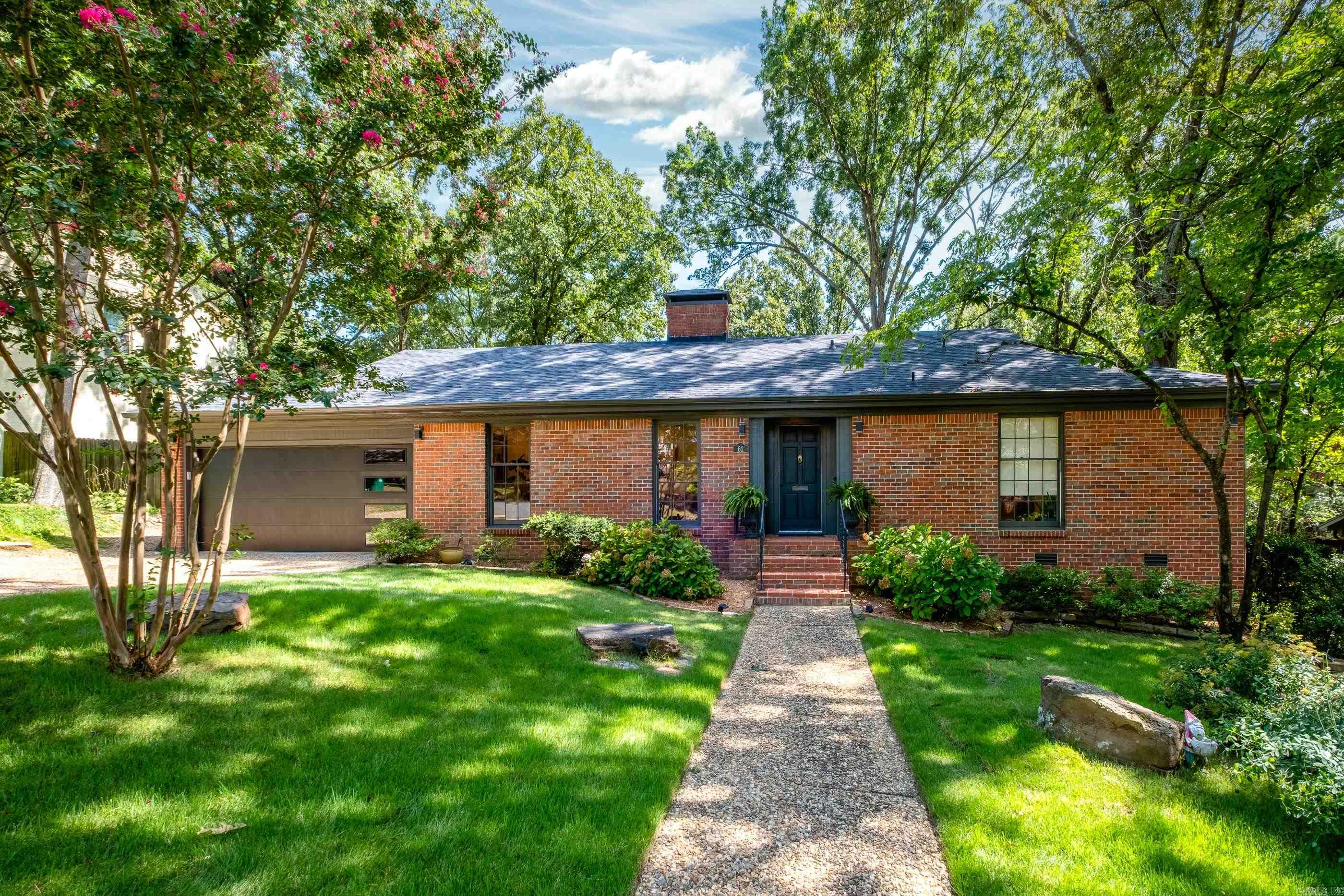 Charming Pleasant Valley Gem with Modern Updates Welcome to this beautifully updated all-brick home in the heart of Pleasant Valley! Offering 1,950 square feet of living space, this 3-bedroom, 2-bath home features two spacious living areas, a cozy fireplace, and elegant site-finished hardwood floors throughout. Enjoy cooking and entertaining in the stylish kitchen with quartz countertops, nearly new GE Profile appliances (installed late 2023), and updated lighting and plumbing fixtures. Both bathrooms boast slab granite vanities and sleek white tile floors and surrounds for a clean, timeless look. The home is packed with recent upgrades, including a new roof (Dec. 2023), new water heater (July 2025), and a new 2-car garage door and opener (June 2025). Step outside to two inviting flagstone patios—one nestled beside a tranquil water feature—and lush Zoysia sod, all maintained by a Rain Bird irrigation system. Located in one of Little Rock’s most established neighborhoods, this home blends classic charm with thoughtful, modern touches. Move-in ready and a must-see!