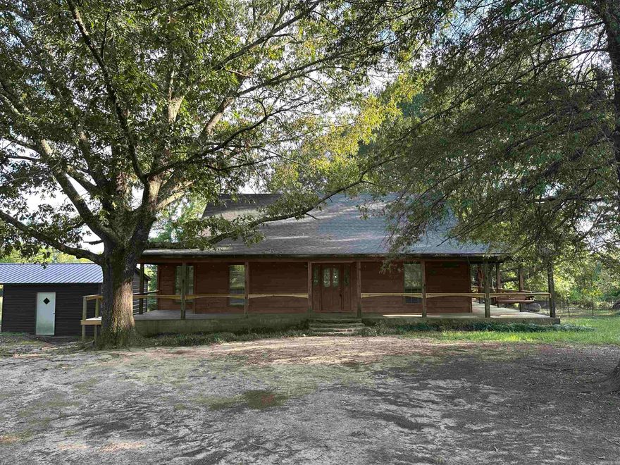 The Farmhouse you've been looking for is on the market in Bismarck! 9.65 acres surrounds this cedar siding home with wrap around front porch and full length rear deck. 3 bed, 2 bath, 1536 sq ft offers an open living/kitchen area, wood flooring, cathedral ceiling, gas logs in the stone fireplace. Bathrooms are roomy and updated. Detached carport/utility shed.  Walk in closets.  3rd bedroom could be an office. Plenty of room for a garden area.