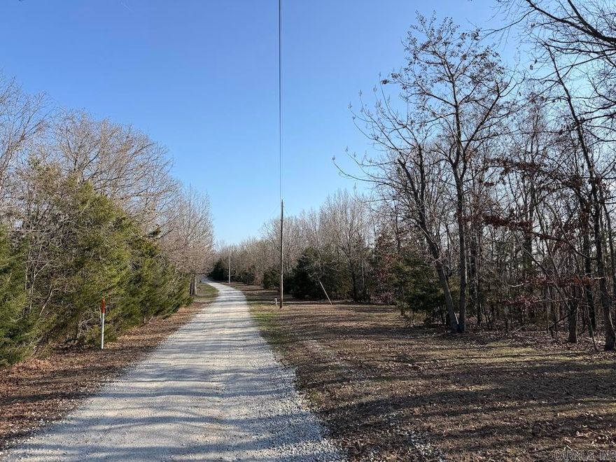 Tucked in the Ozark hills near Bergman in Boone County, this 7-acre tract offers a private, scenic setting with convenient access. The land features mature hardwood timber, including white and red oak, along with scattered cedar trees and an open, easy-to-navigate forest floor. A great building site sits just off a well-maintained gravel road, with electric available, making it ideal for a home or retreat. The property gently slopes east and northeast, offering potential for beautiful valley and mountain views with light clearing. Natural wooded benches add character and usability for trails, recreation, or landscaping. Enjoy a quiet country feel while staying close to Bull Shoals Lake, Harrison, and Branson for fishing, boating, shopping, and dining. A rare find with manageable acreage, strong building potential, and classic Ozark beauty.
