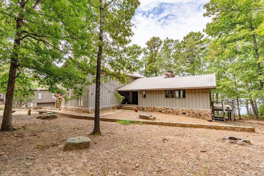 Lakefront retreat. 3 levels of decks to enjoy the pristine views of Greers Ferry Lake. 2 car garage with plenty of parking for friends and family. Metal Roof.  Main level is primary sweet. Upper level with two guest rooms and bath. Very large game room and bunk room with wet bar.