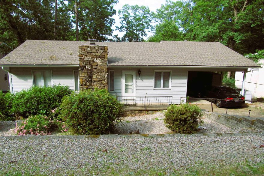 Charming 3 bed/3 bath home in a quiet area of Hot Springs Village with 1738 square feet of living space located in the desirable Jessieville School District. Step out on the spacious deck and enjoy the peaceful surroundings.  Lower level includes one bedroom/1 bath and a huge storage area with a separate entrance. The gated entrance offers peace of mind and security in addition to all the great amenities that HSV has to offer to include: 9 golf courses, swimming pools, many recreational lakes, beaches, covered pavilions, tennis and pickleball courts and 2 full service marinas just to name a few  There is a one time buy-in fee of $2000.00 to purchase a home in Hot Springs Village.