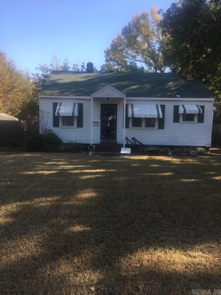 Charming home in the heart of West Memphis with original hardwood flooring under the carpet, a shop, and a fenced yard.