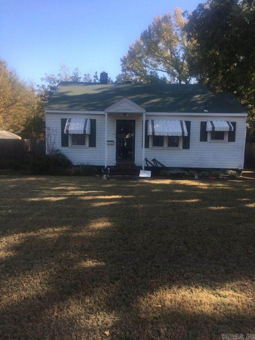 Charming home in the heart of West Memphis with original hardwood flooring under the carpet, a shop, and a fenced yard.