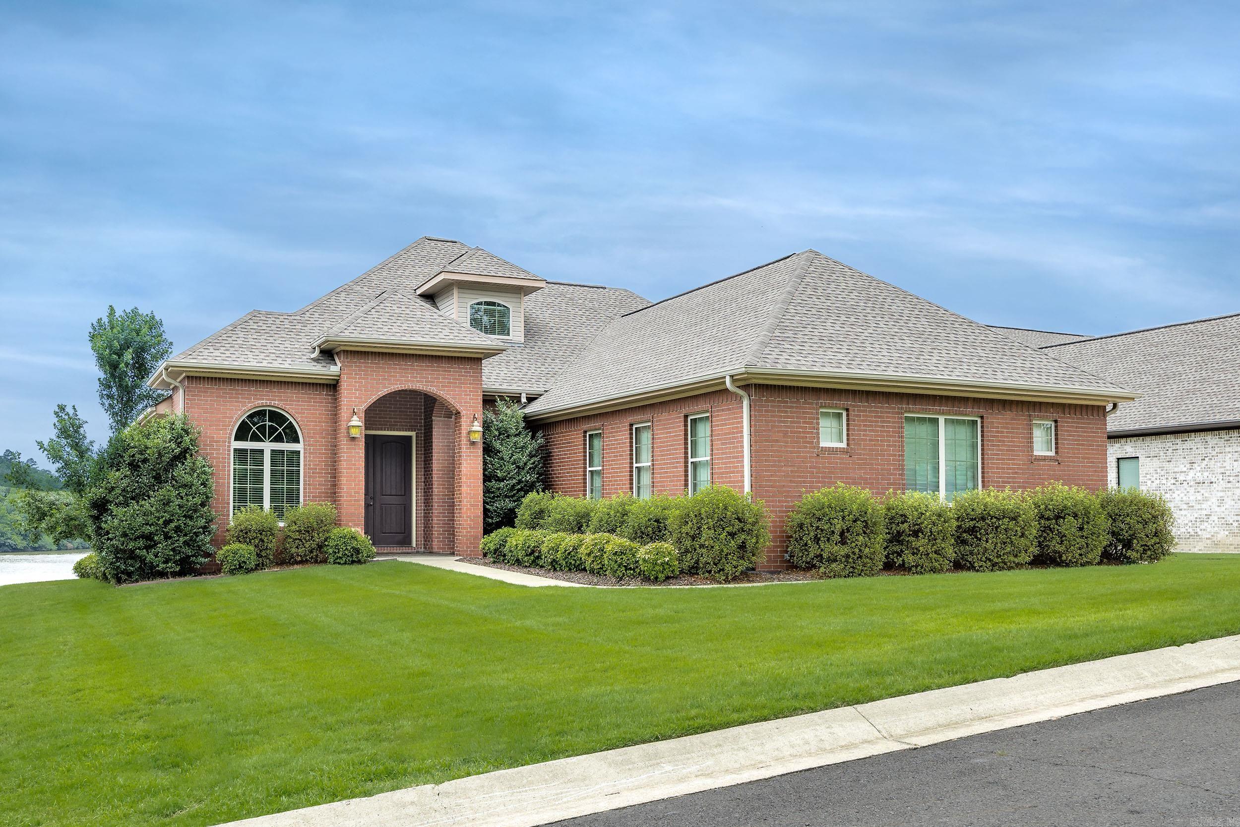 Furnished Lakefront Estate in Gated Community! Welcome to an exceptional waterfront residence where luxury, comfort, and natural beauty converge. Perfectly positioned to capture breathtaking sunsets, this impeccably maintained home offers effortless elegance in a gated community. Step inside to soaring 11-foot ceilings in the formal dining and living areas, with an open-concept layout ideal for entertaining. The gourmet kitchen features granite countertops, a built-in oven and microwave, separate cooktop, and custom cabinetry—combining style and practicality. The main level features elegant porcelain tile flooring, three spacious bedrooms, and two and a half baths. Upstairs, a private guest suite offers its own bath and a refined sitting area, creating a peaceful retreat. The 4-car garage provides ample room for all your lake gear and more. Savor the best of lakefront living from the comfort of a covered patio, overlooking beautifully landscaped grounds that gently slope down to your private two-slip boat dock—each slip equipped with its own lift. Schedule your showing today!