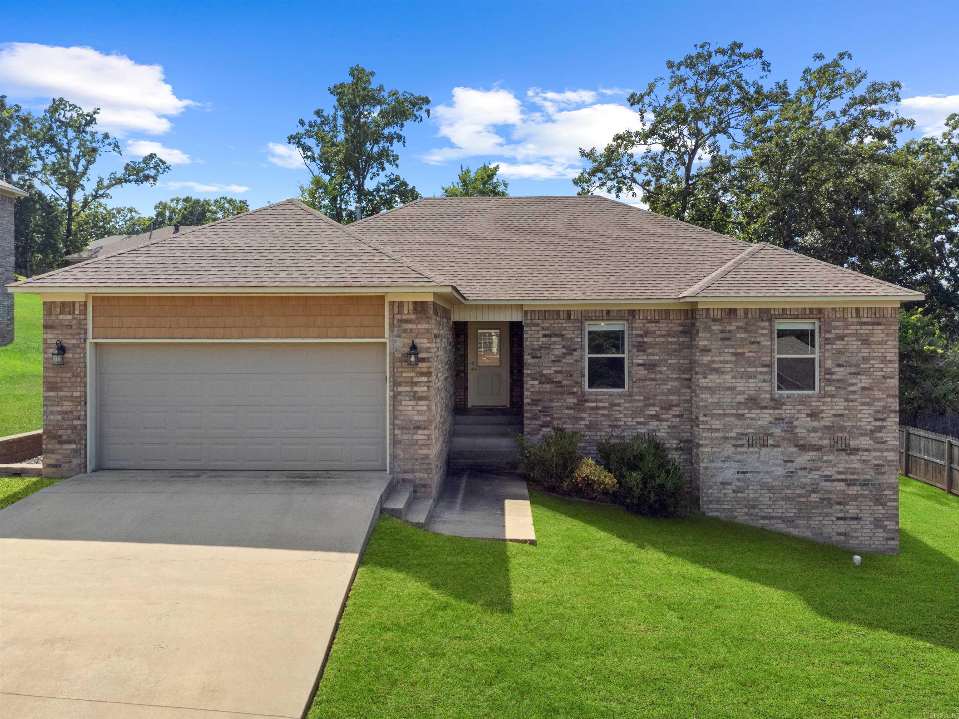 Welcome to this charming all brick 3 bedroom 2 bath home located in the desirable Magness Creek Subdivision! This home feature's a split floor plan and an open layout ideal for both Everday living and entertaining. Gorgeous wood floors flow throughout the main living areas, highlighted by a cozy fireplace and custom cabinetry. The kitchen boasts stainless steel appliances, ample storage, and a seamless connection to the living dining areas. The spacious primary suite includes his and her sinks and a walk in closet. Enjoy outdoor living in the large backyard with plenty of space to entertain, play or simply unwind. Residence of Magness c Creek can enjoy the scenic lake, playground, and tennis courts. Don't miss the opportunity to call this home!