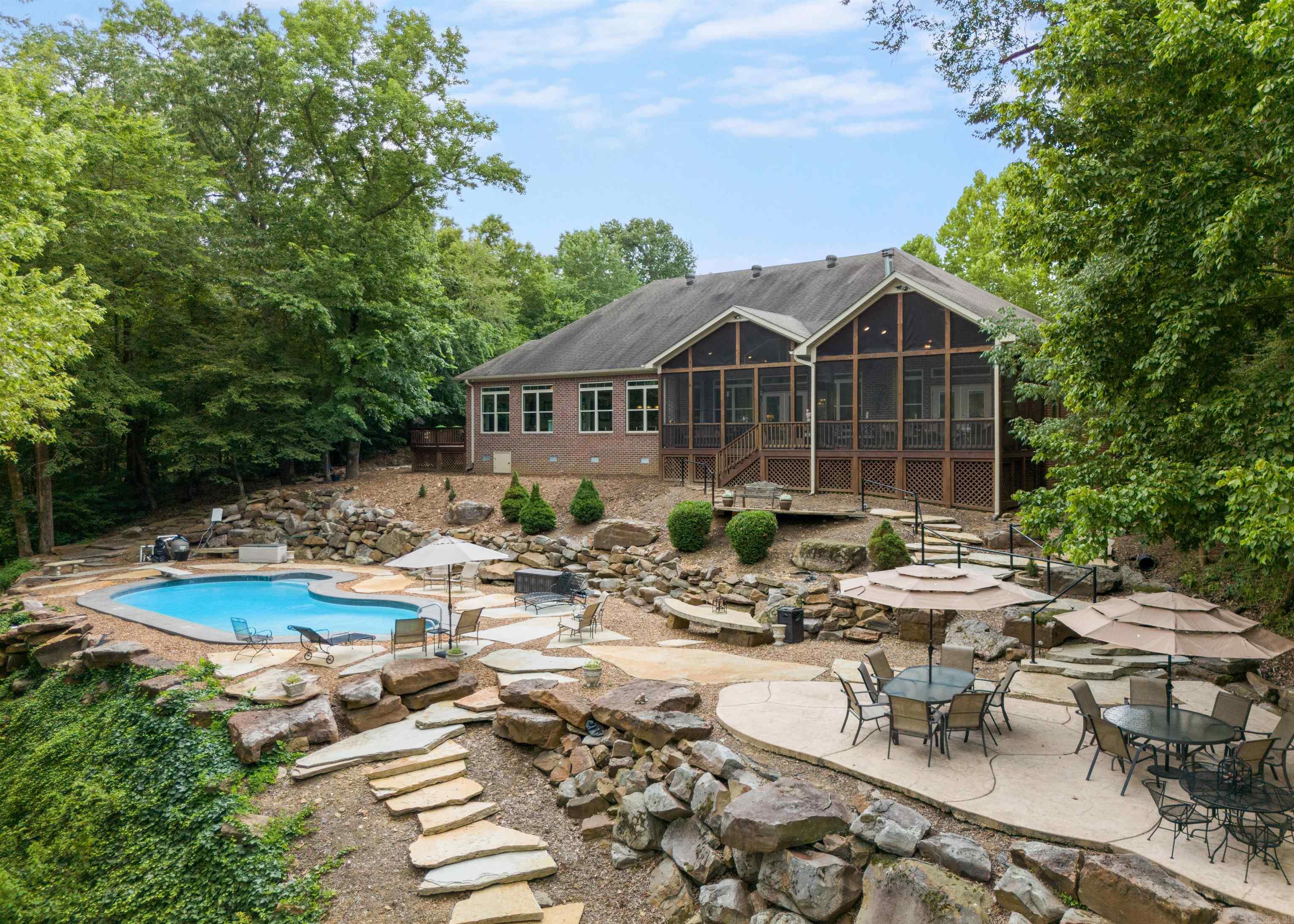 This property seamlessly combines the charm of "The Natural State" w/ the peaceful beauty of both the quaint town of Searcy and the tranquil Little Red River. Located just 4 miles from the townās amenities, it offers the perfect mix of convenience & seclusion, making it a truly unique find. Nature is right at your doorstep, with features like a large dock with boat lift, a pool & adjoining patio, expansive deck, screened porch, firepit with string lights, & the chance to enjoy kayaking & paddleboarding on the river. Nestled amidst this natural beauty is a custom 4-bedroom, 4.5-bath home, designed to create a warm, welcoming atmosphere ideal for both family living & entertaining. Even in winter, you can enjoy breathtaking views & a cozy ambiance through large windows & the wood-burning fireplace. As you step through the solid wood double doors, the open layout and panoramic river views immediately captivate. The spacious kitchen, w/ a massive center island, double ovens, & gas cooktop, is a chefās dream. Upstairs, a bedroom with a private entrance, kitchenette, & sitting area offers the perfect space for AirBnB guests or a family suite. hidden gem you'll want to call your own.