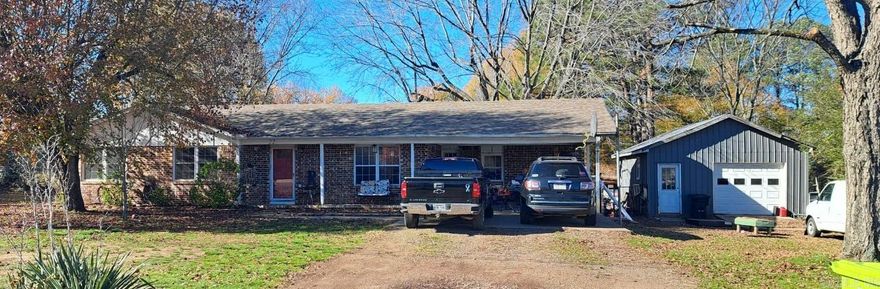 Beautiful 4 bedroom brick home sits on more than half an acre.  This home has an attached carport and a 10x10 concrete patio off the back patio. Make the 20x25 heated and cooled shop into your "man cave" or "she shop." The lean to behind the shop is nice shop for your lawnmower and the rest of your outdoor tools. The owners are leaving the stainless steel appliances, playhouse, swingset, firepit sitting area with swing and chairs and above ground pool so you can enjoy them in your new home.