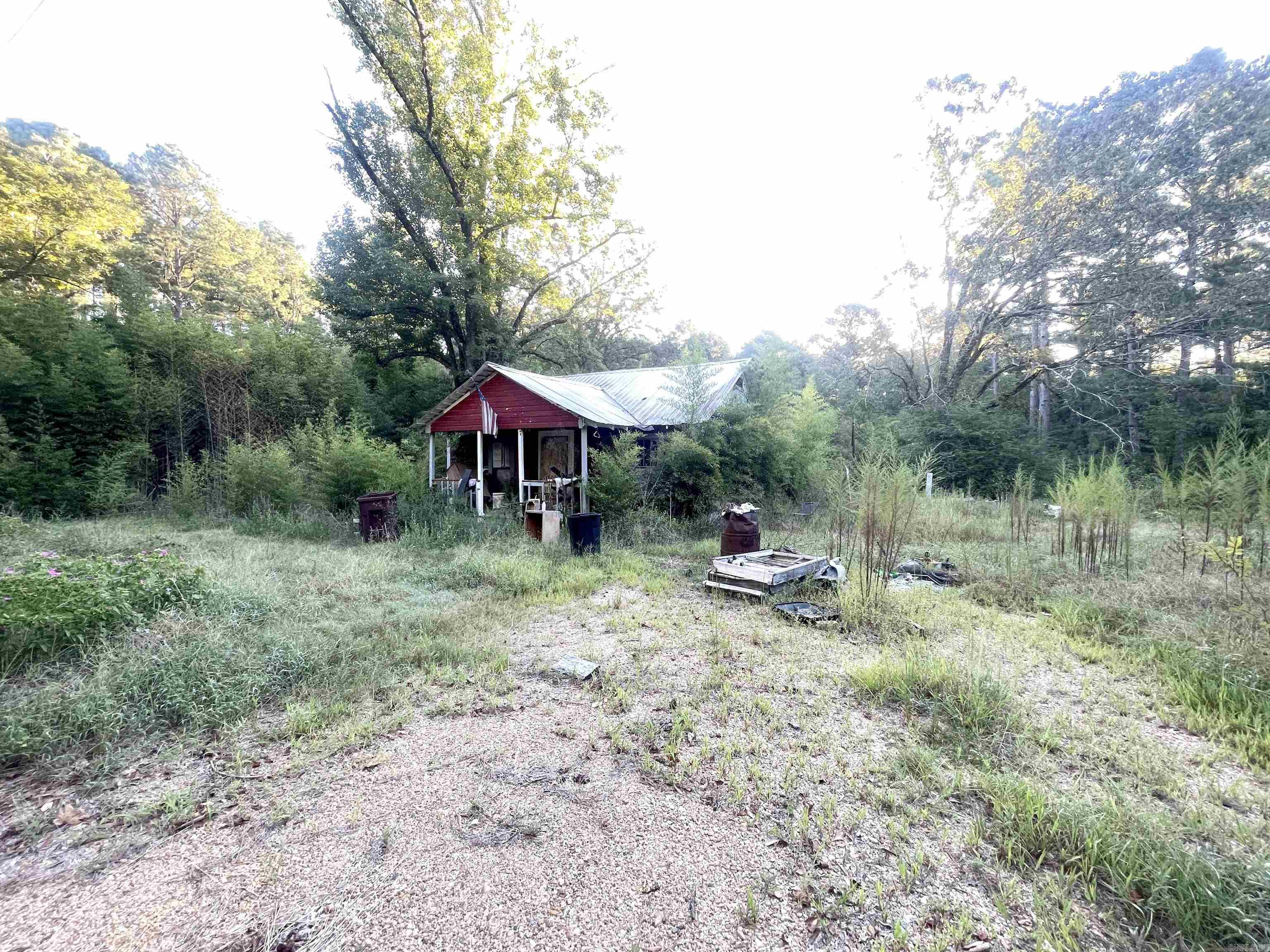 Beautiful piece of country land! Nestled in Locust Bayou, this 26 acre parcel offers a current residence that needs restorative work (sold as-is), as well as a mobile home site to the right of the main house. The owners have enjoyed hunting a variety of game in the wooded portion, the majority of the acreage.