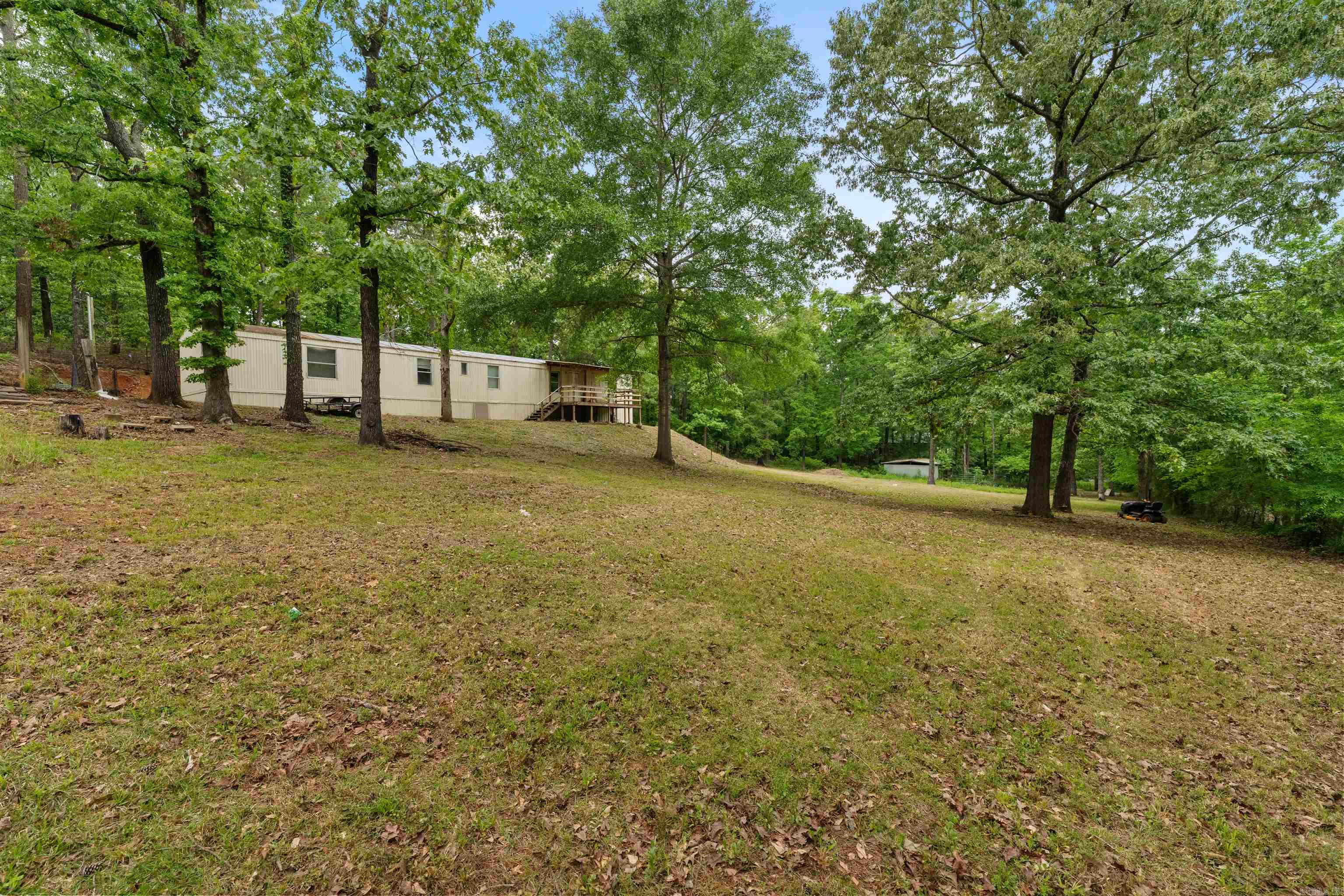 Nestled in the serene landscapes of Roland AR this meticulously maintained mobile home offers a perfect blend of comfort and tranquility. The home boasts brand new flooring, enhancing both aesthetics and durability. Equipped with the latest appliances, the kitchen is ready for culinary adventures. The layout promotes a seamless flow between living, dining and kitchen areas, creating an inviting atmosphere. The generous 1 acre lot offers endless possibilities for landscaping, recreational activities or future expansions. You can enjoy peace and privacy away form the hustle and bustle. This property is ideal for those seeking a comfortable and peaceful living environment with added benefits of modern upgrades and ample outdoor space. Whether you're a first time homebuyer, looking to downsize, or seeking a serene retreat, this home is a must-see
