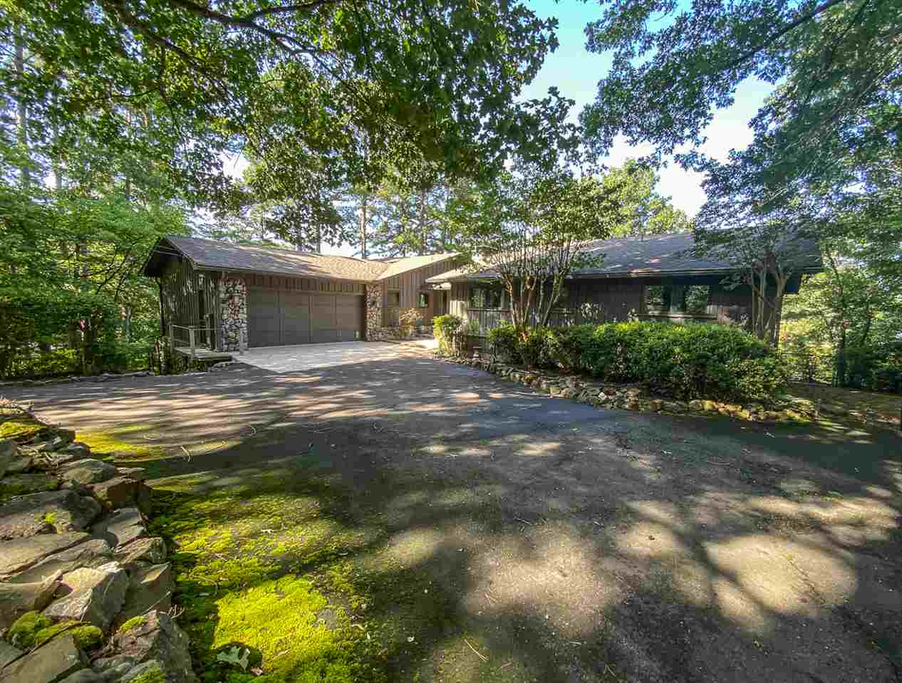 THE ALLURE OF TRANQUILITY IS PREVALENT IN THIS SPRAWLING ESTATE ON A PEACEFUL POINT LOT ON LAKE HAMILTON. A gated entry leads to a serene setting filled with an abundance of greenery, azaleas, camellias, dogwoods, and the gentle sound of water splashing along the banks.Included on the property is a greenhouse, storage shed, & a FANTASTIC heated & cooled workshop/garage for the avid car enthusiast. Another added bonus is the covered boat dock w/ lift and seadoo parking pads.