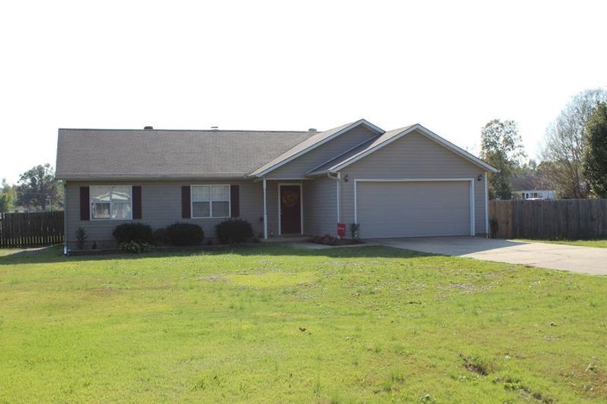 Great home situated on a peaceful acre lot. Inviting family room offers wood laminate flooring and cozy wood burning fireplace. Dining room is located just off the family room and leads to kitchen that boasts abundant oak cabinetry. The spacious bedrooms include a relaxing master suite with large vanity and dressing area. Home has been well maintained including a newly installed heat and air unit and roof. Other amenities include a screened-in porch, a deck, a two car garage, a workshop and privacy fence.