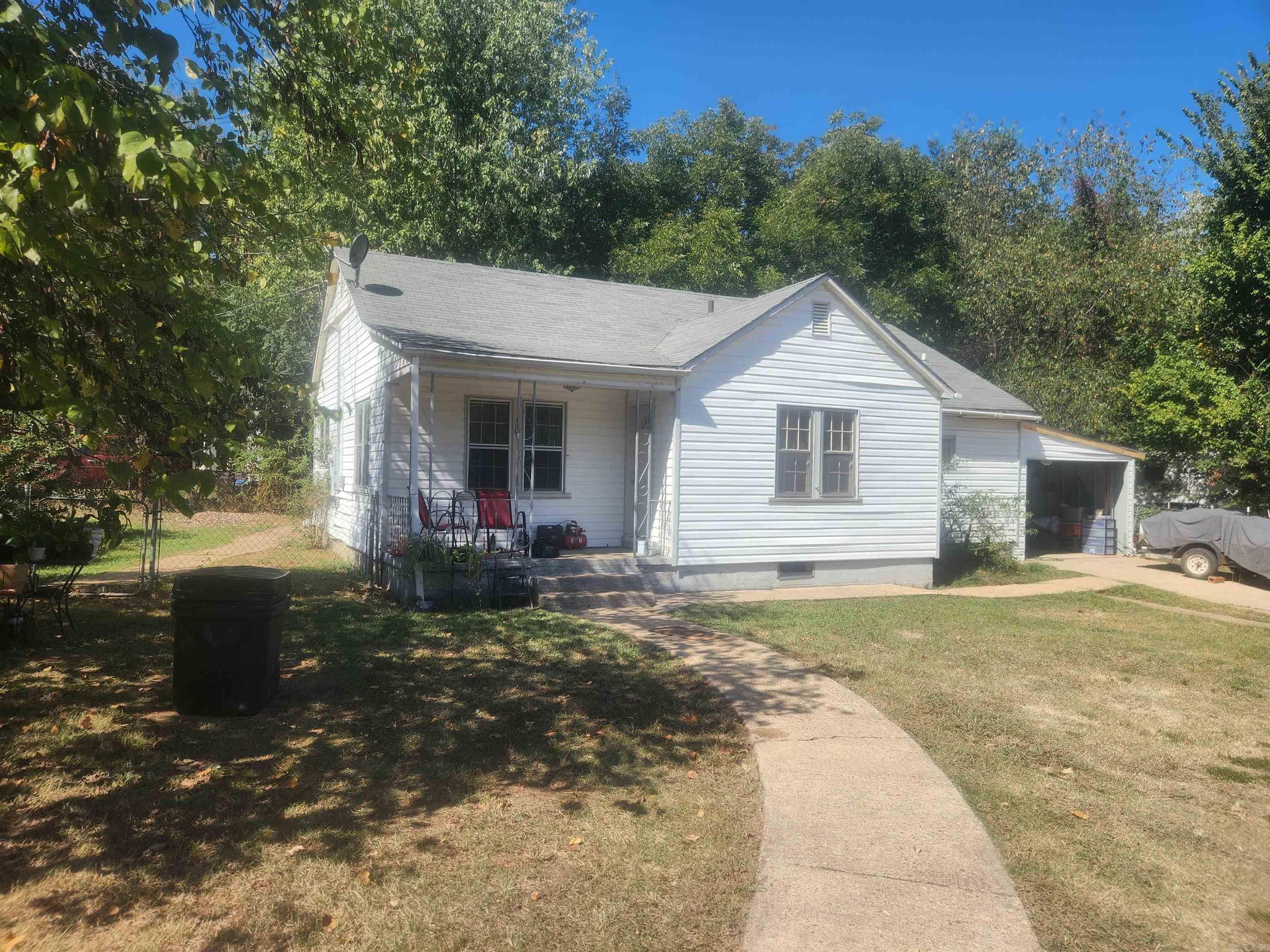 Nice cottage home on a good size corner lot with lots of pluses! Plenty yard with sidewalks leading front and back, front porch, garage/shop in back, attached one car carport fenced back yard are just some of the amenities. Inside lots of charm, big kitchen, wood floor in living room, big bathroom. plenty of space and potential to make this one just what you are dreaming of.