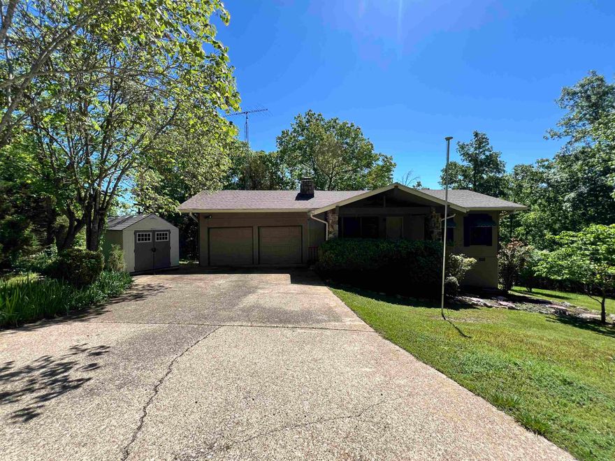 Presenting your secluded sanctuary in the heart of Cherokee Village! This charming 3-bedroom, 2-bath retreat offers unparalleled privacy, nestled amidst lush woods with no neighboring homes in sight. Enjoy the tranquility of nature from your doorstep, with the convenience of a paved road leading to your haven. Featuring a newly installed architectural shingle roof and a modern heat pump, this home ensures comfort and peace of mind year-round. With a spacious third bedroom downstairs, a vaulted ceiling great room, a cozy wood-burning fireplace, a two-car garage, and a convenient storage building, this property is the epitome of comfort and convenience. Don't miss the chance to make this serene escape your own!