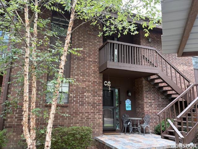 Enjoy the tree covered grounds and sound of the water running through the creek leading to the lake, right from your back deck! This complex offers a park like setting throughout for a tranquil experience. This owner has all of the heavy lifting items done for you. HVAC, carpet, dishwasher and disposal all less than 2 years old plus a brand new water heater. Both the living area and primary suite open to the back deck overlooking the lake. In addition to the deck along the back of the condo, there are 2 smaller decks off of the dining area, perfect for your grilling needs. Parking is a breeze with 2 assigned spots, one of which is covered and both close to the front door. With a wood burning fireplace, winters can be cozy in the large living area overlooking the lake. The complex also offers a pool for your summer time fun. Be sure to check this property out today! No Nightly Rentals allowed.